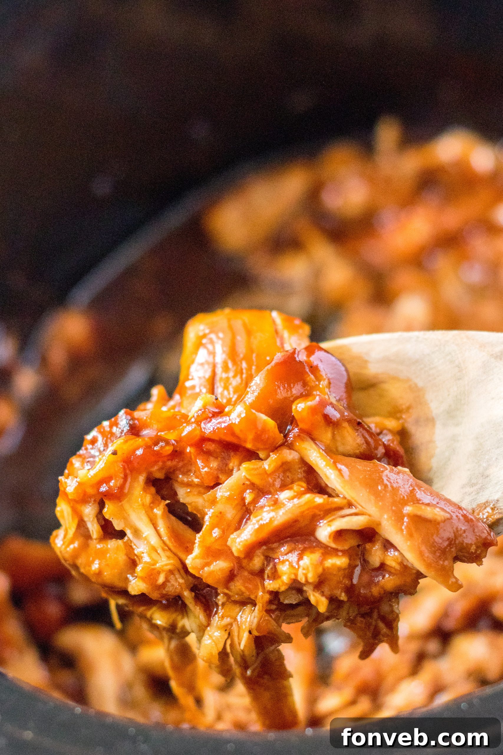 Close up of a slow cooker filled with shredded Root Beer Chicken