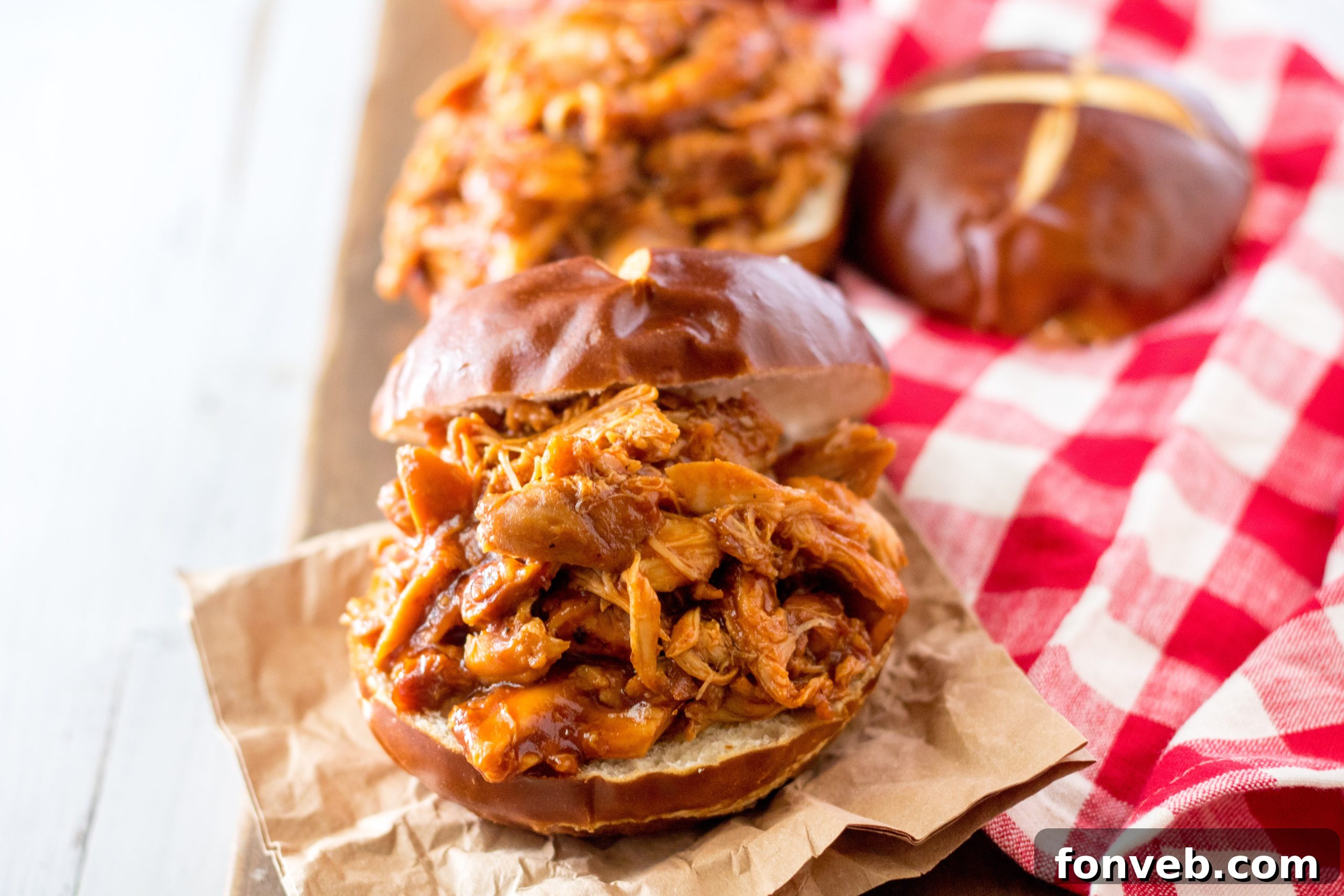 Shredded Slow Cooker Root Beer Chicken served on a bun with toppings