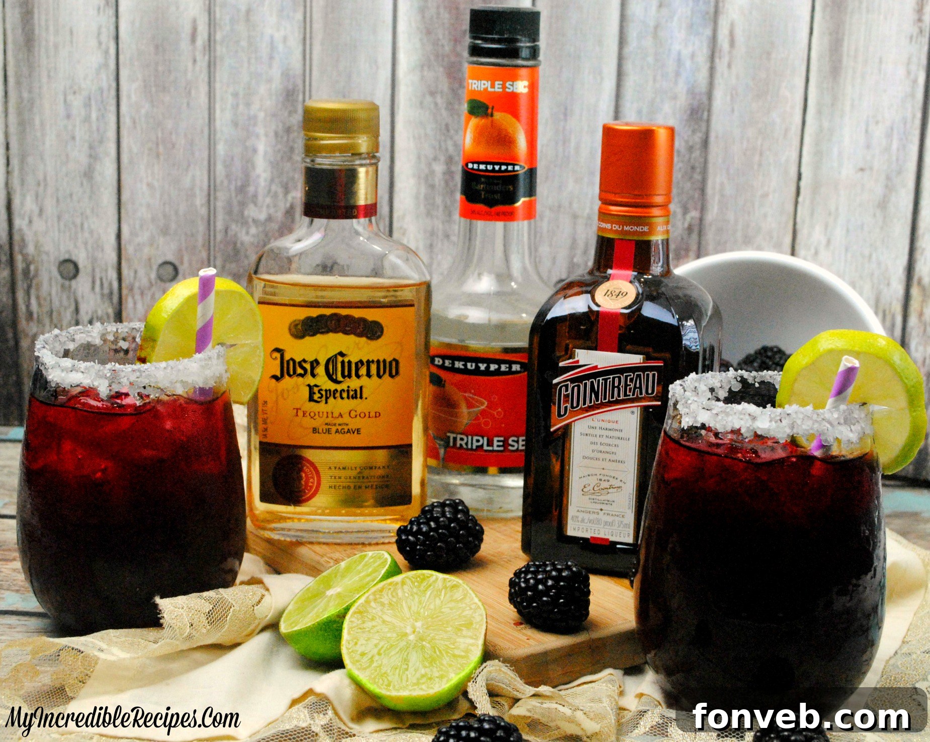 Three Blackberry Margaritas with various garnishes, including limes and fresh berries