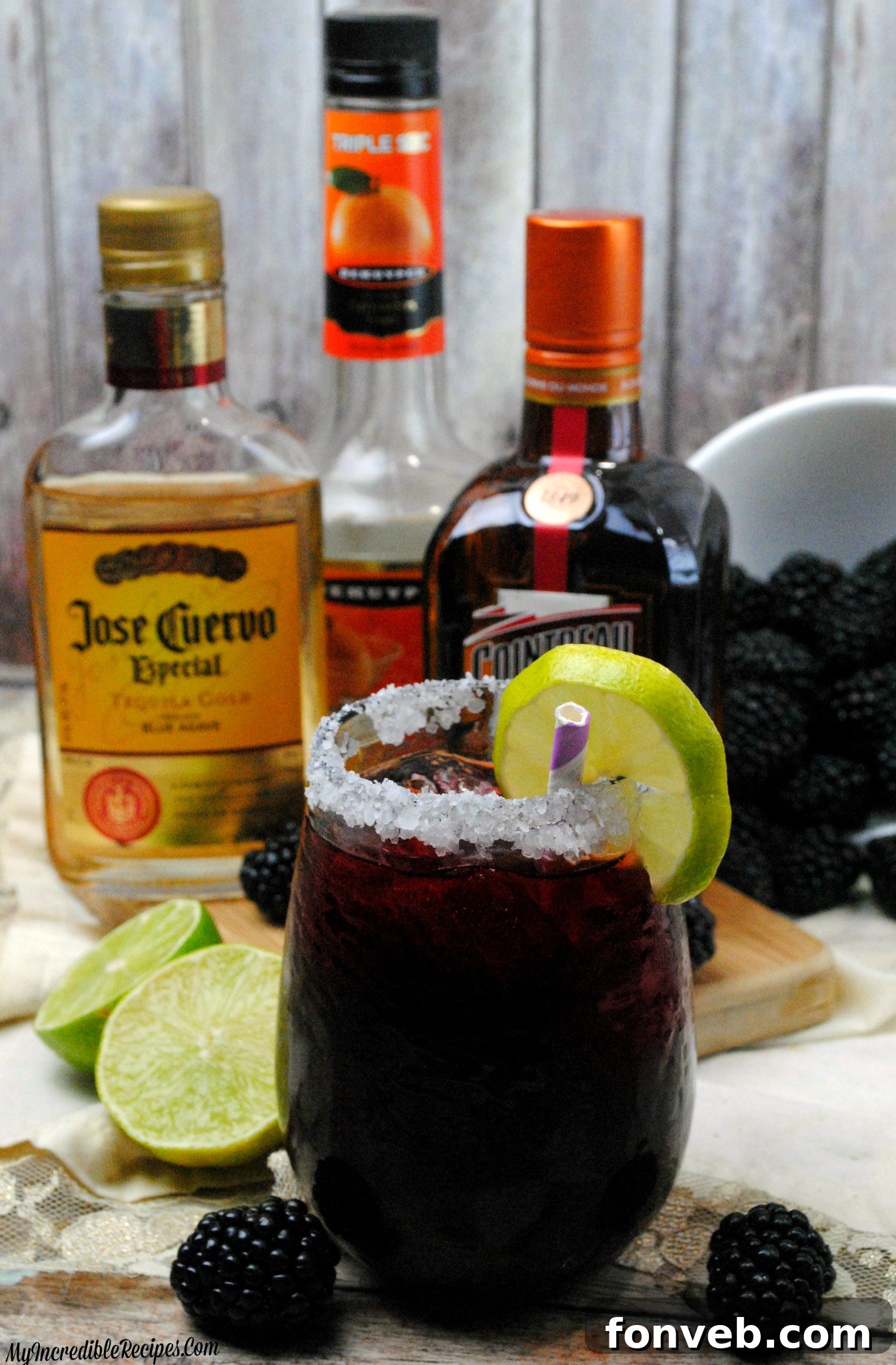 Hands preparing a Blackberry Margarita with a shaker and fresh berries