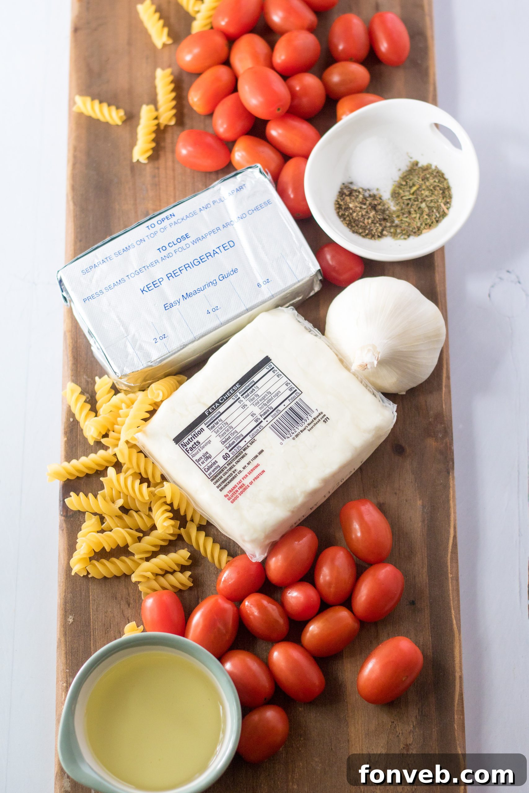 Close-up of the Slow Cooker Tomato and Feta Pasta, highlighting the melted feta and cream cheese coating the tomatoes and pasta.