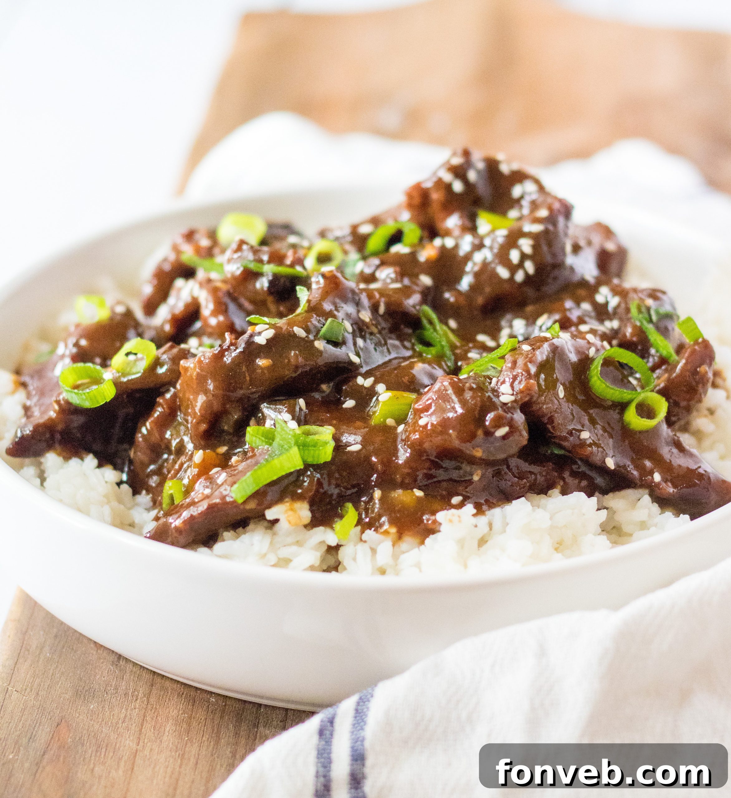 Slow Cooker Mongolian Beef Delight 7 Slow Cooker Mongolian Beef in a bowl with chopsticks