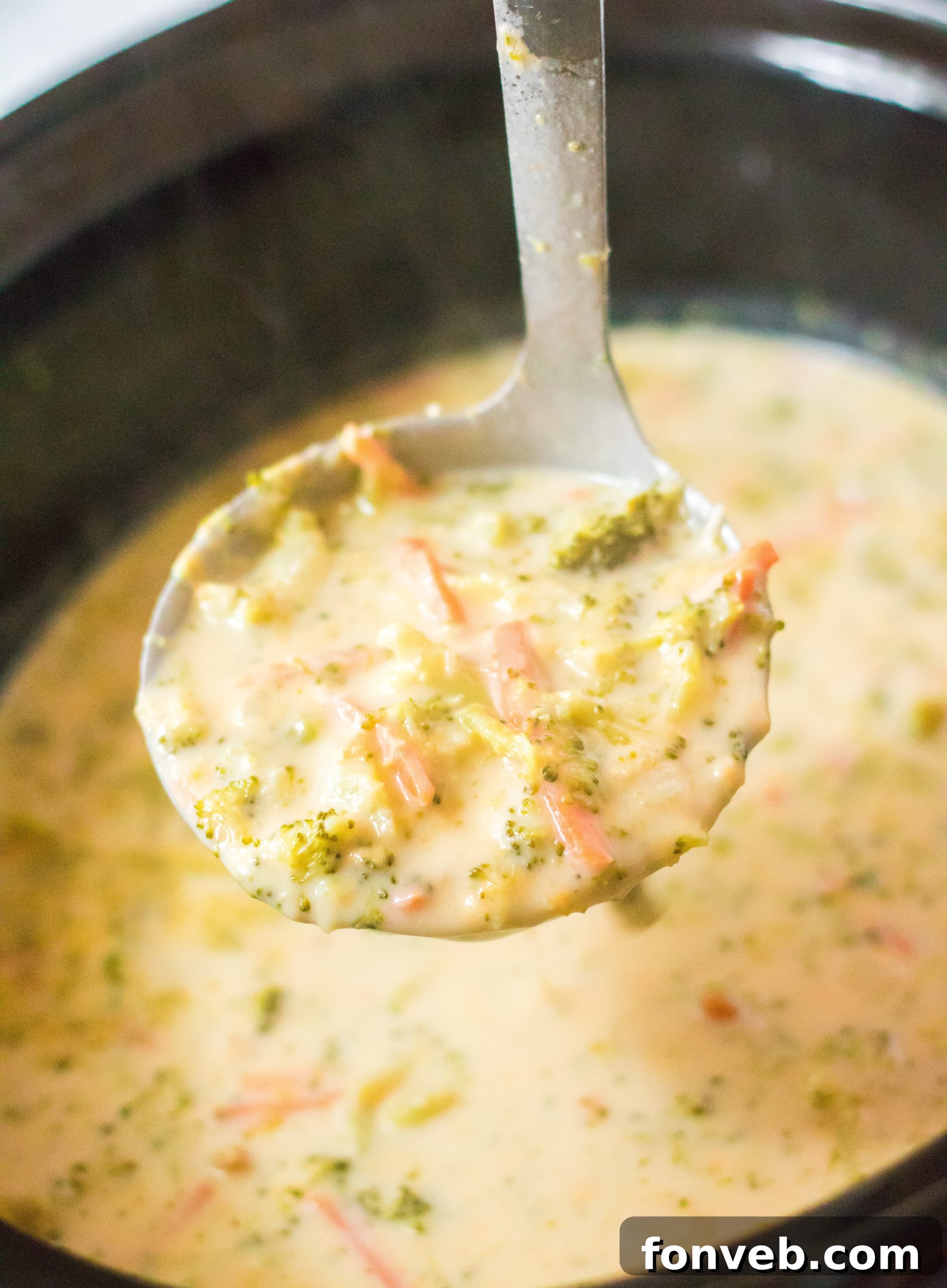 Delicious Slow Cooker Panera Broccoli Cheddar Soup in a rustic bowl with crusty bread