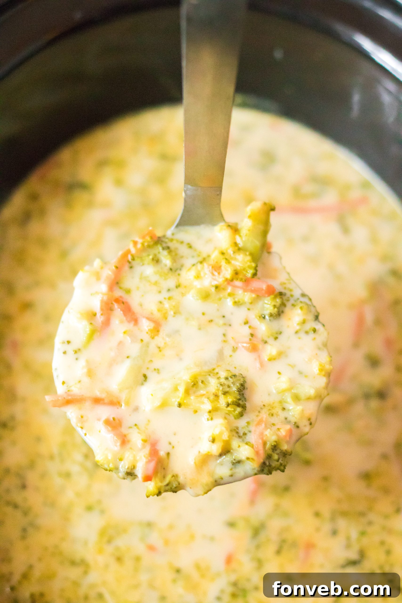 A large serving bowl filled with creamy broccoli cheddar soup, ready for sharing