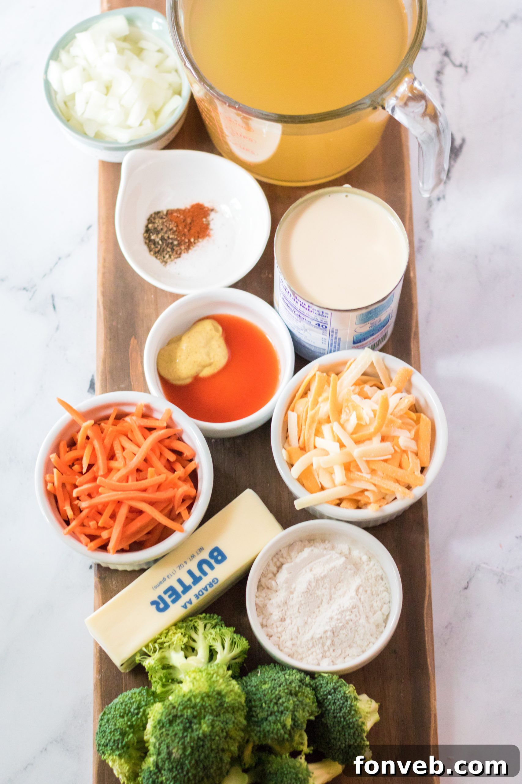Close-up of a spoon dipping into creamy broccoli cheddar soup, showing melted cheese