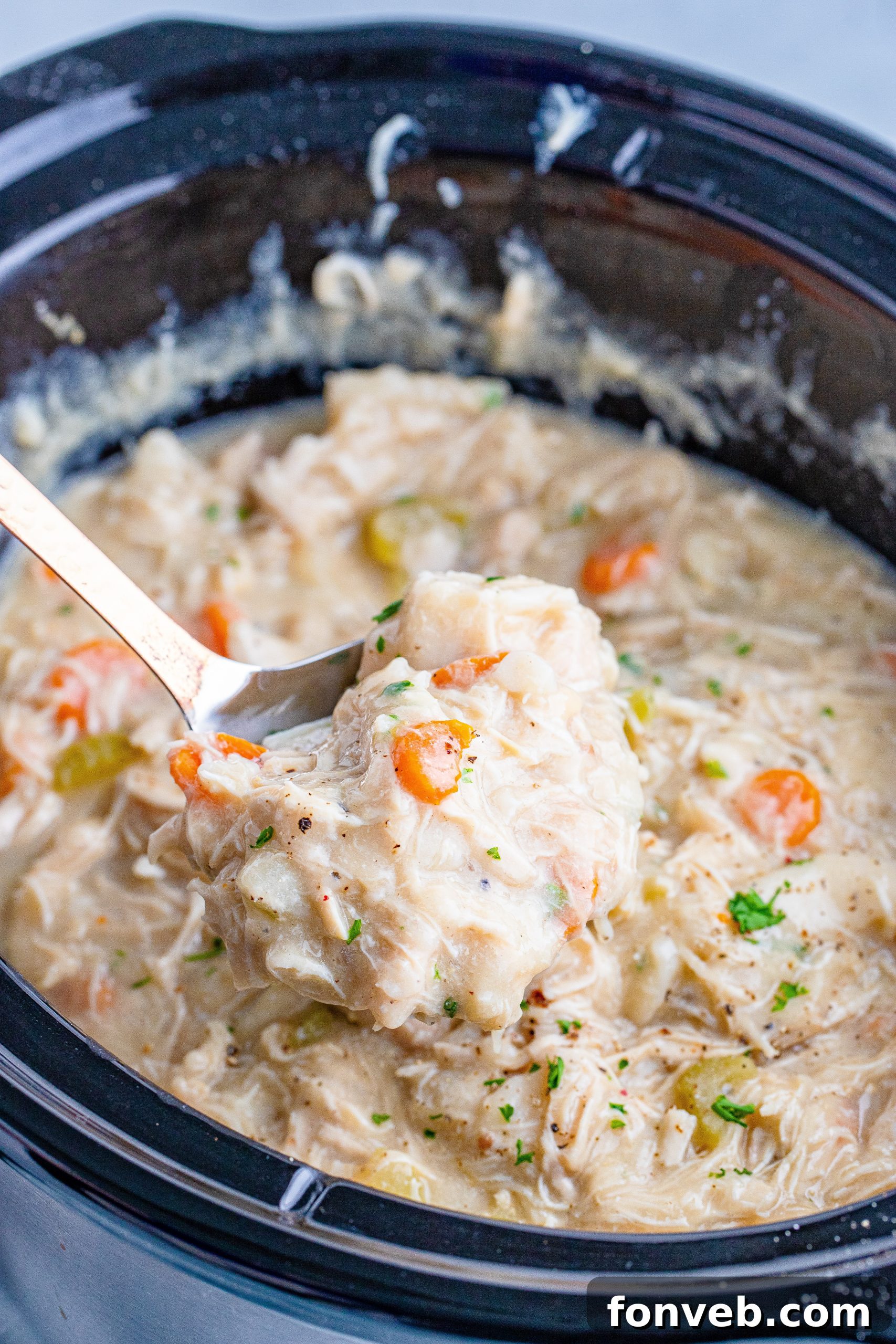 Leftover chicken and dumplings stored in clear food containers in the refrigerator