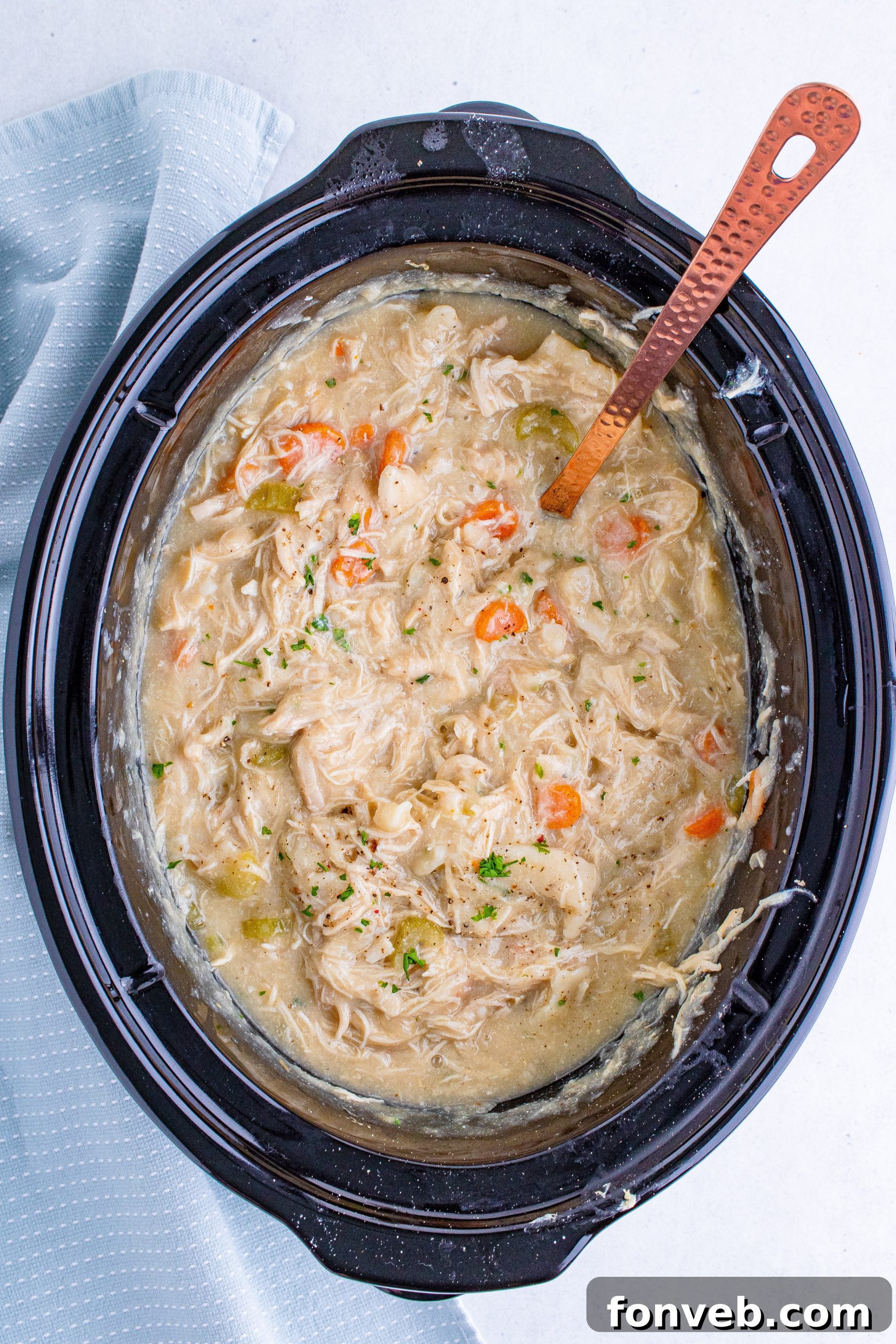 Diced chicken breasts seasoned with salt and pepper, ready for the slow cooker