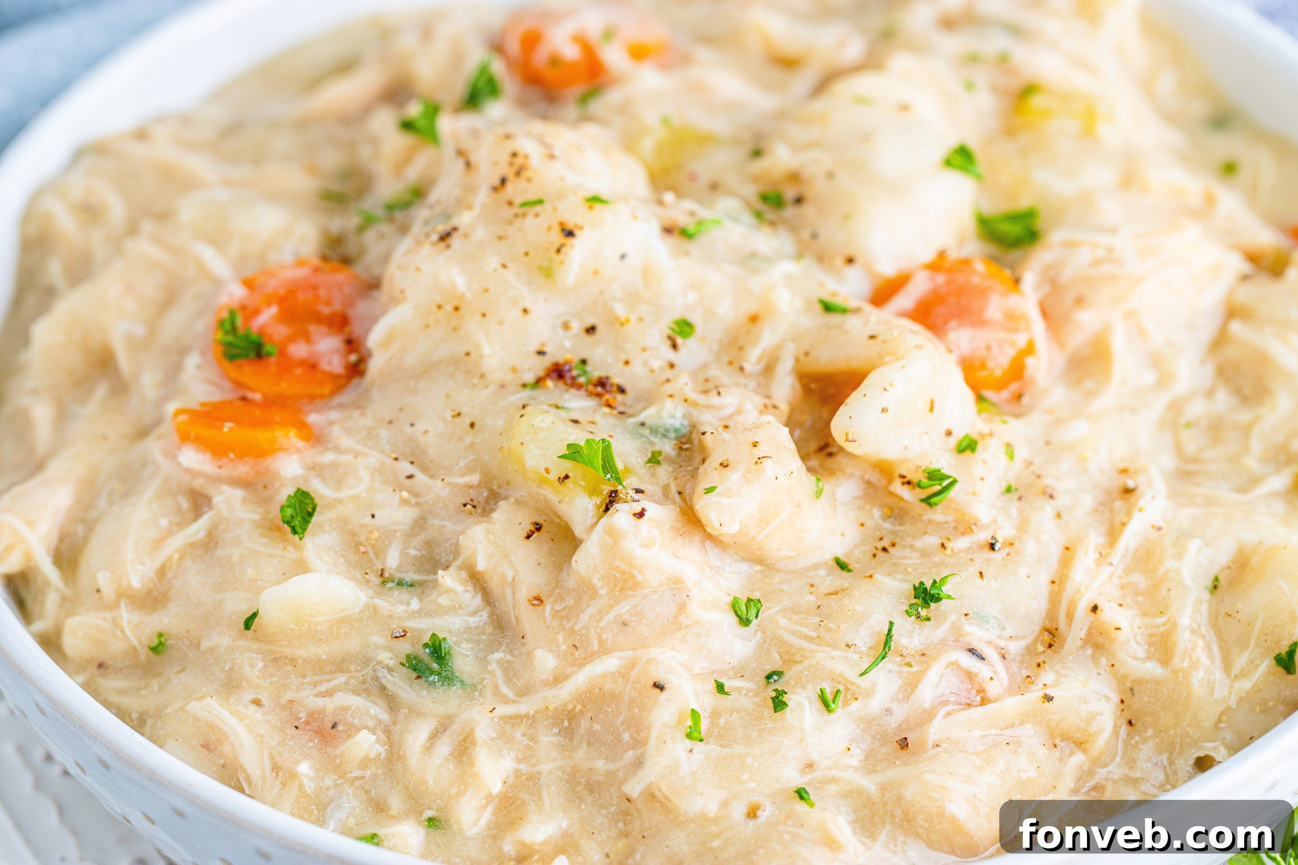 Fresh broccoli florets, carrots, and celery stalks on a cutting board, ready for cooking