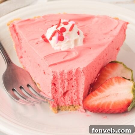 Finished Strawberry Kool-Aid Pie with a slice removed.