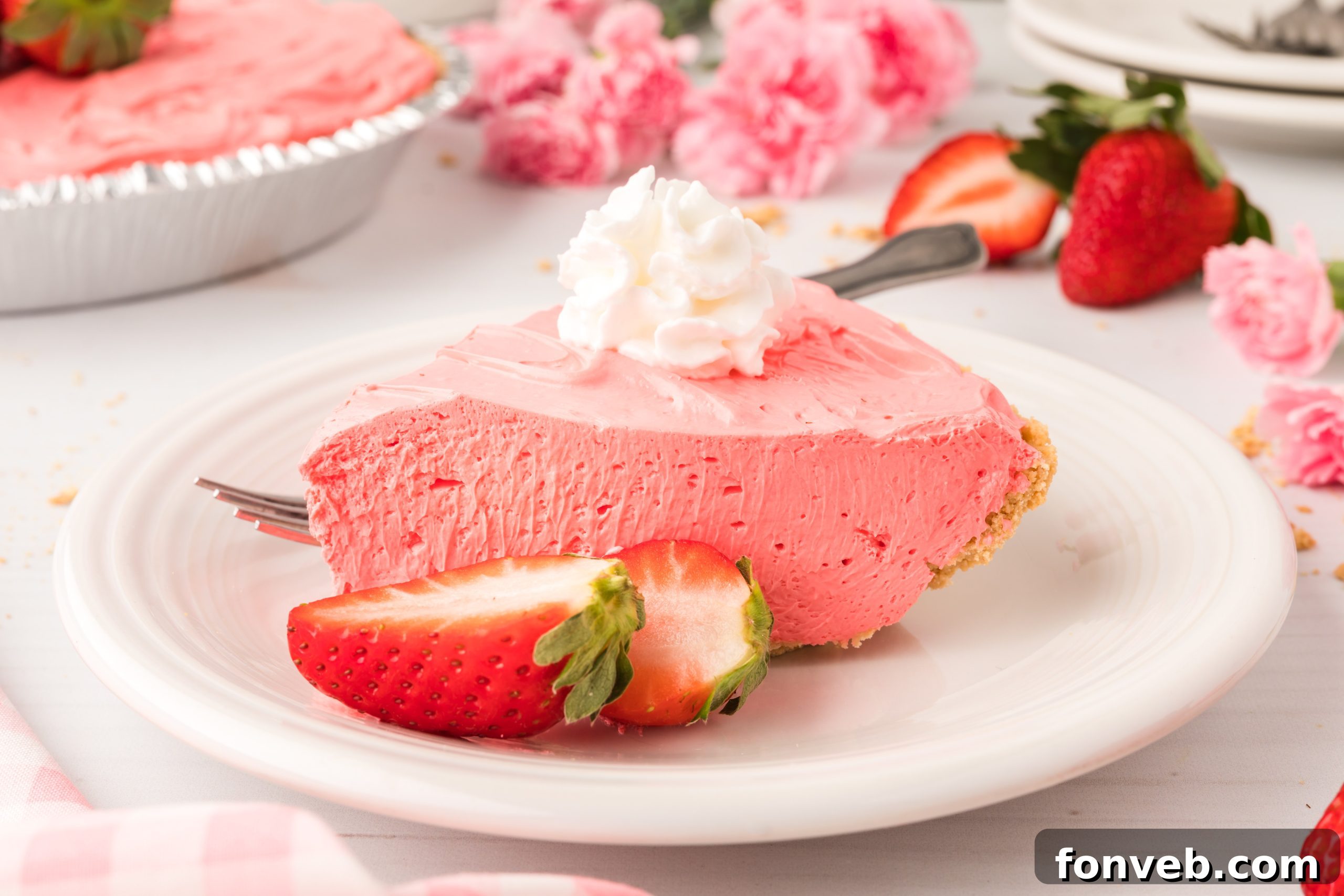 A vibrant Strawberry Kool-Aid Pie resting in a graham cracker crust.