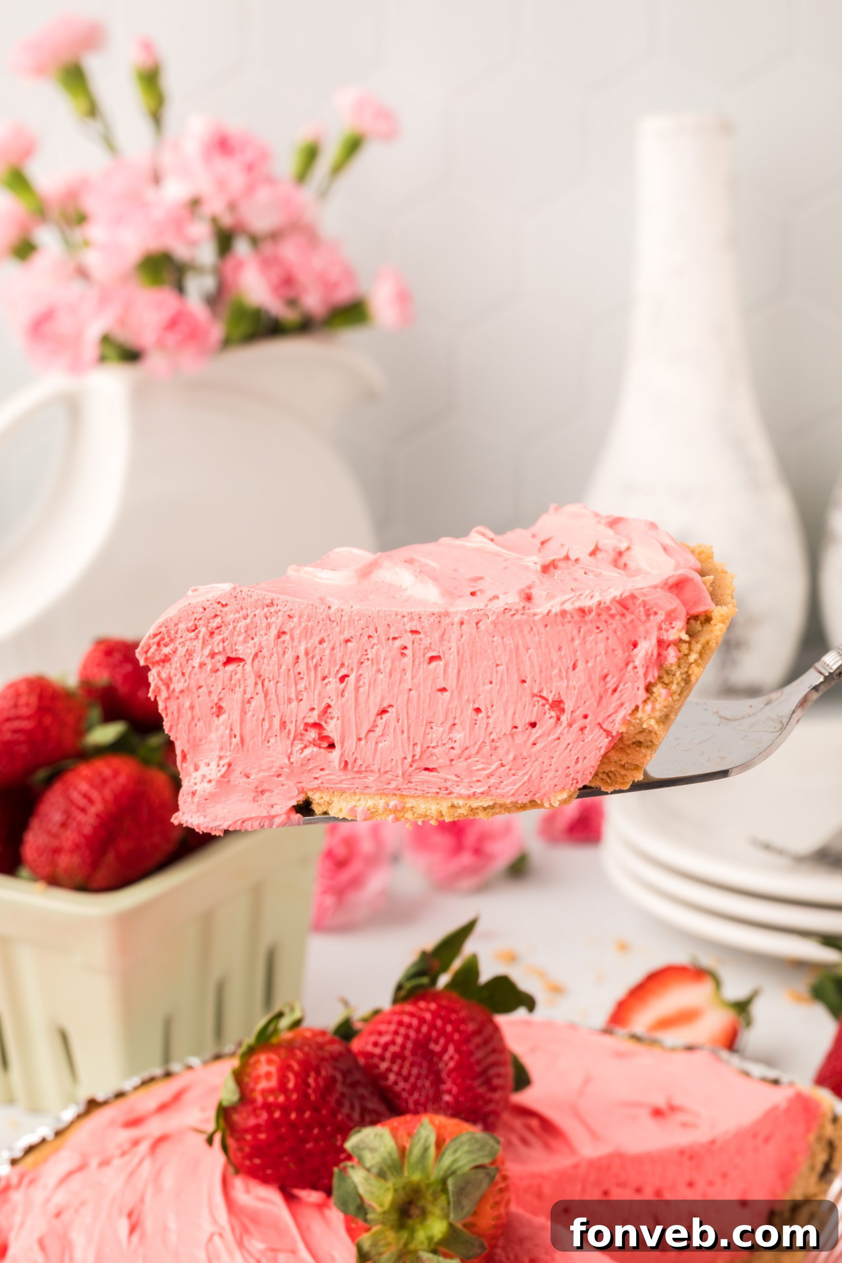 Hands scooping the creamy Strawberry Kool-Aid pie filling into a crust.
