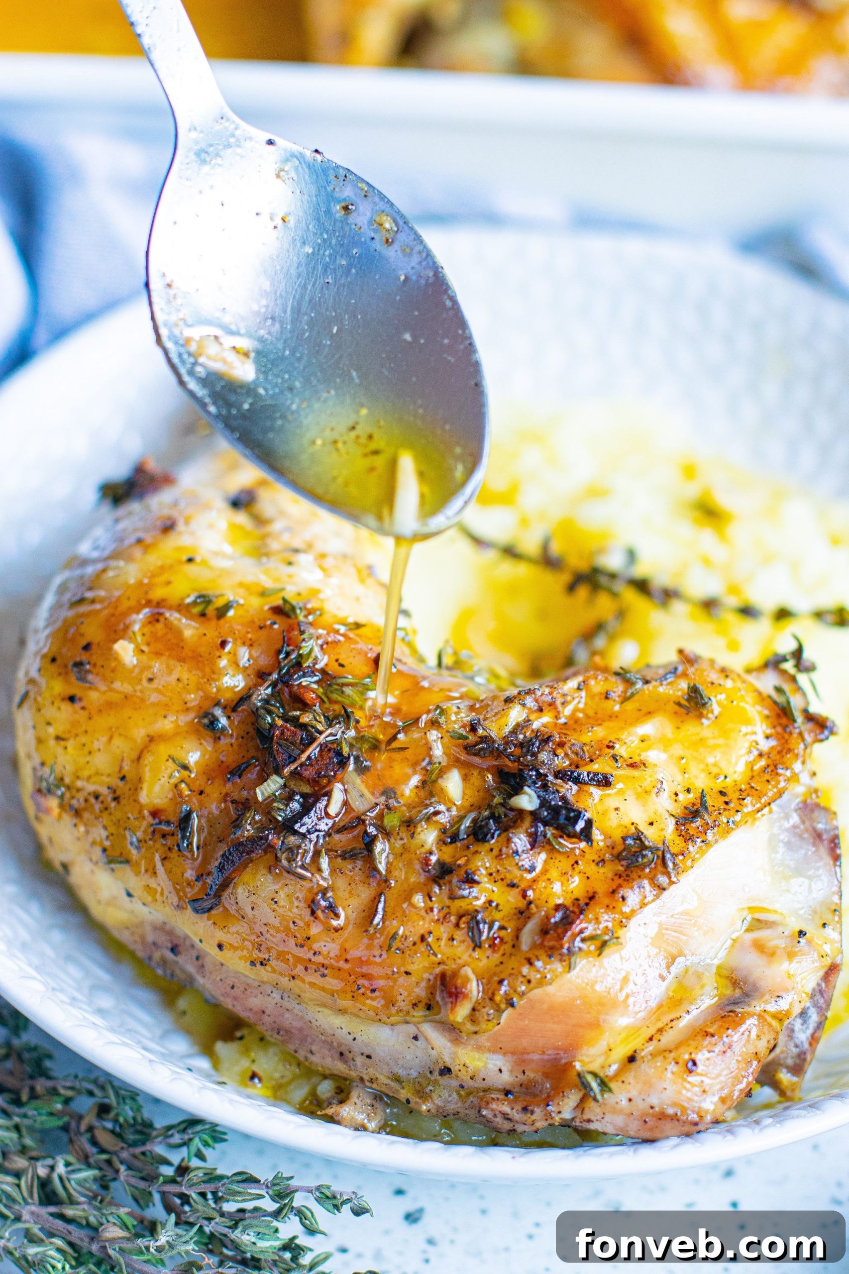 Raw chicken thighs in a baking dish, seasoned and ready for the garlic butter mixture.