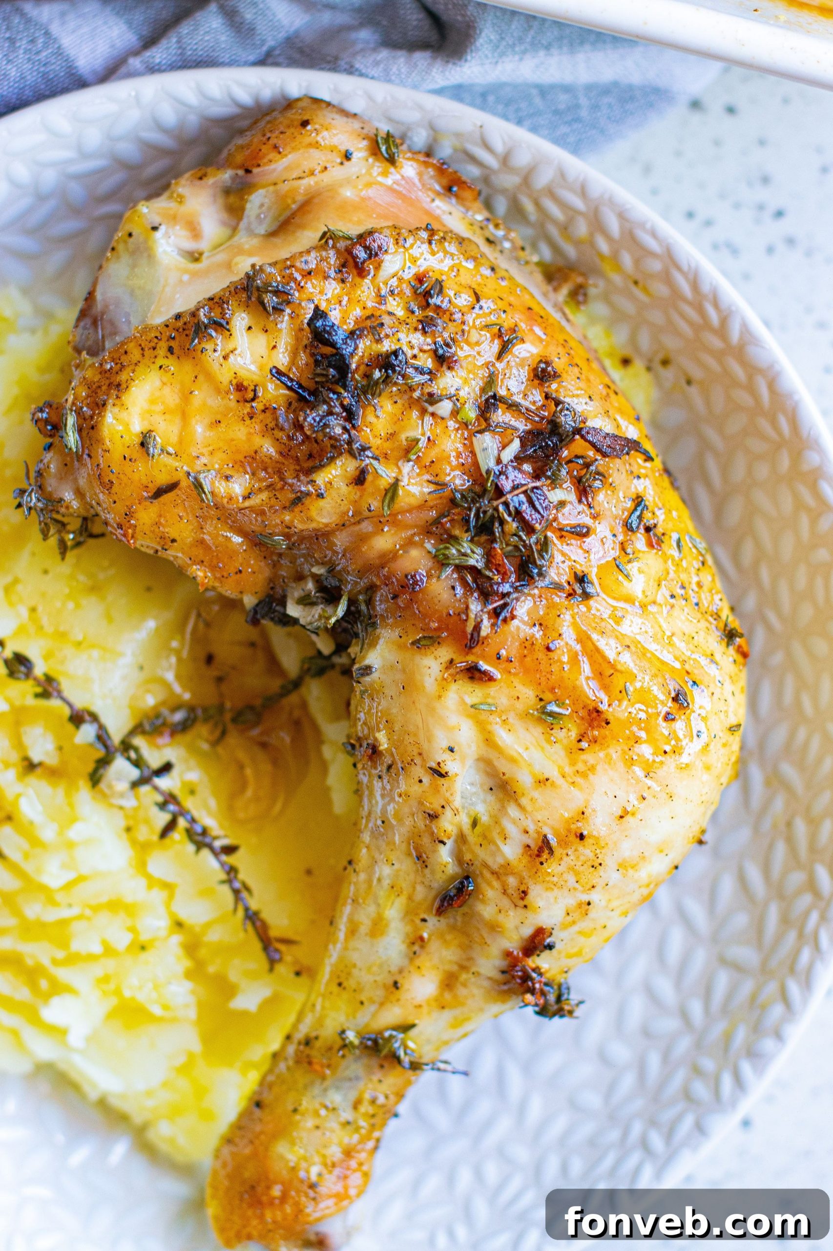 Ingredients for garlic butter chicken laid out: chicken thighs, garlic, butter, thyme, olive oil, salt, and pepper.