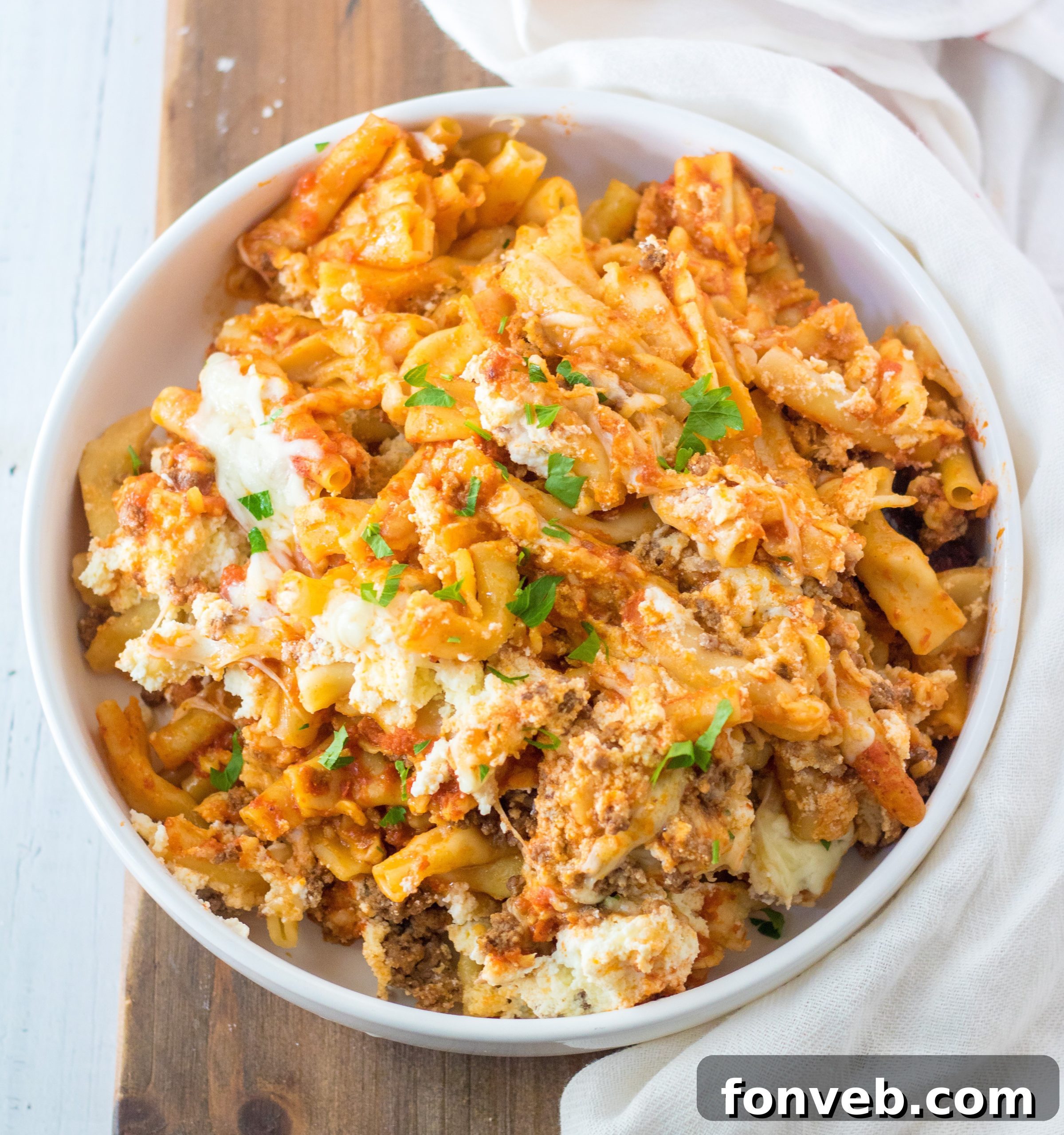 Slow Cooker Cheesy Baked Ziti served with a side salad and garlic bread.