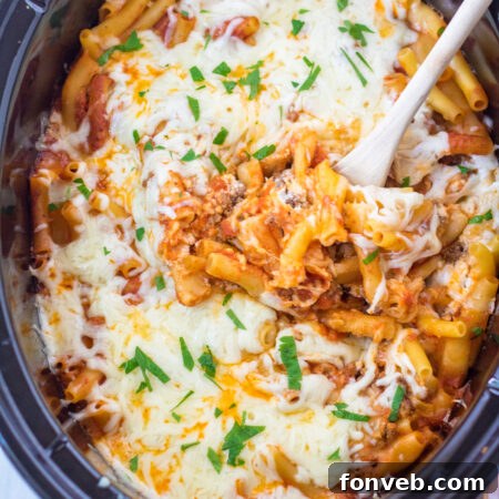A beautiful close-up of the Slow Cooker Cheesy Baked Pasta in a serving dish, highlighting the melted cheese.