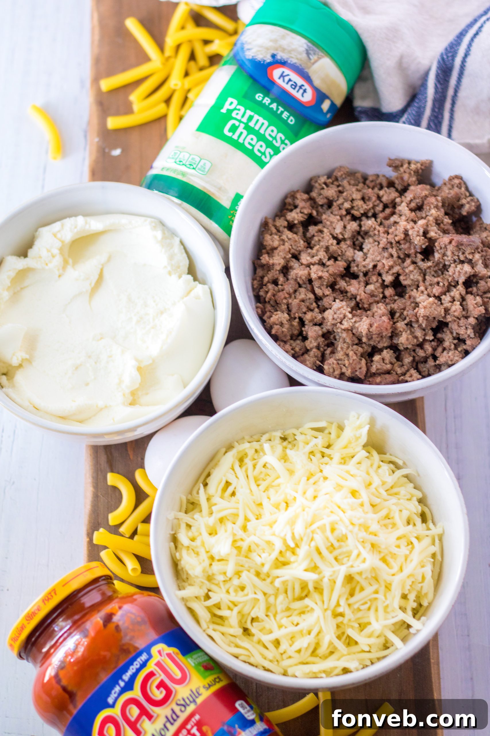 Close-up of baked ziti in a slow cooker, showing layers of pasta, meat sauce, and melted cheese.
