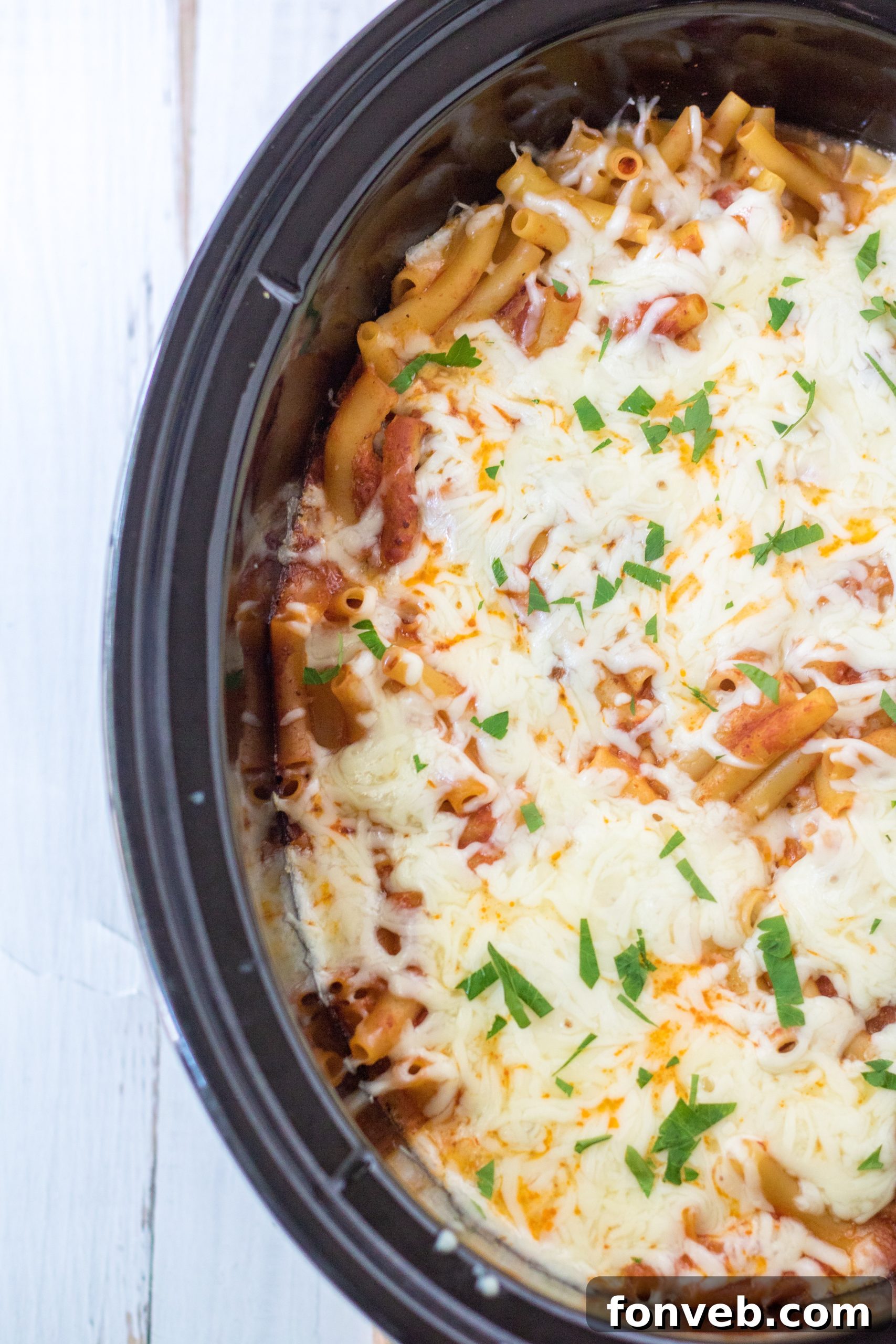 A bowl of Slow Cooker Cheesy Baked Ziti, showcasing the rich layers of pasta, sauce, and cheese.