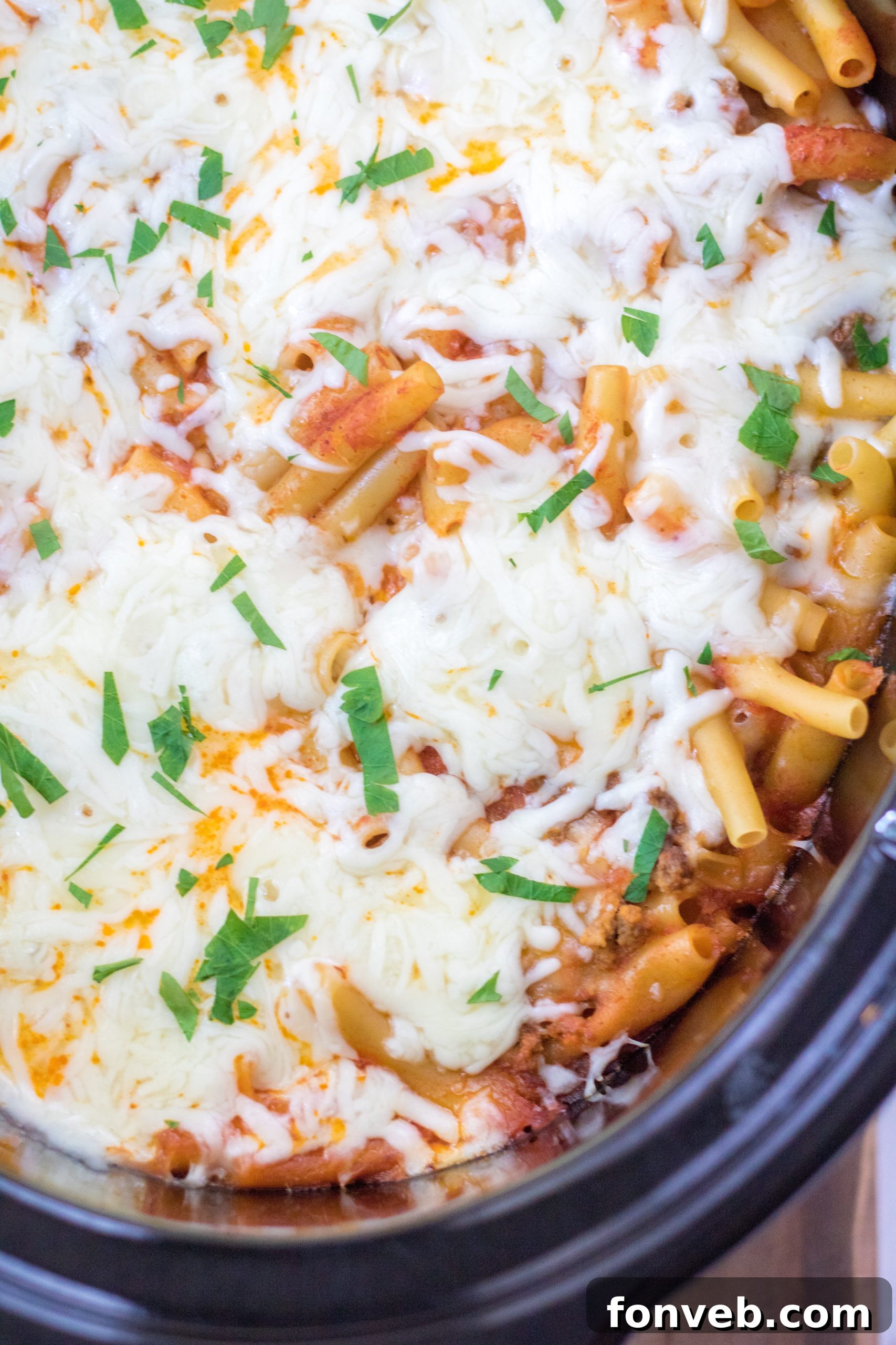 Close-up of a serving of Slow Cooker Cheesy Baked Pasta, with rich sauce and gooey cheese.
