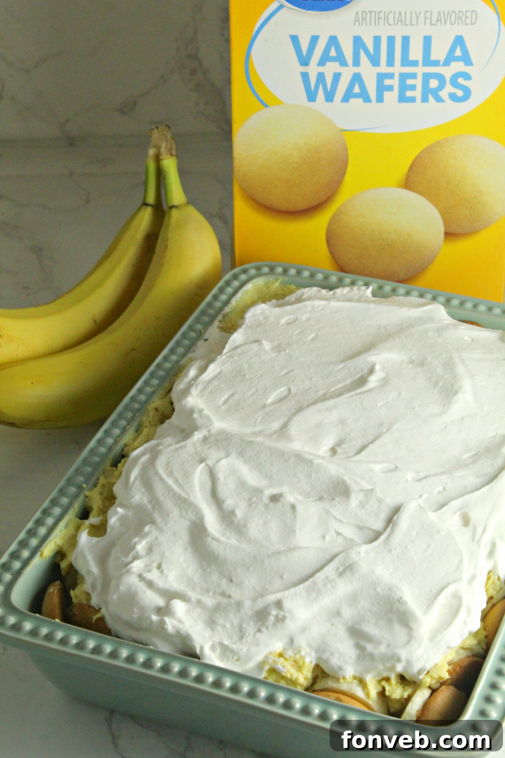 Simple Chilled Banana Pudding 5 A close-up shot of the top layer of fluffy whipped topping on the banana pudding.