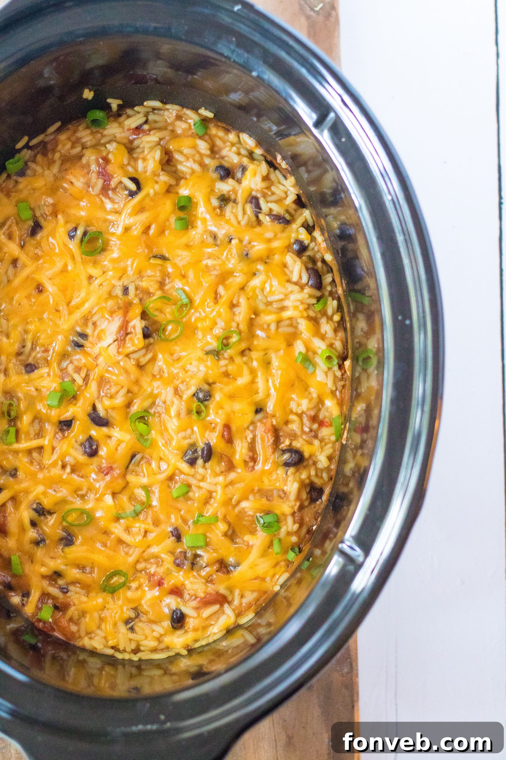 Creamy Slow Cooker Cheesy Chicken Taco Rice 7 Slow Cooker Cheesy Chicken Taco Rice garnished with cheese and scallions