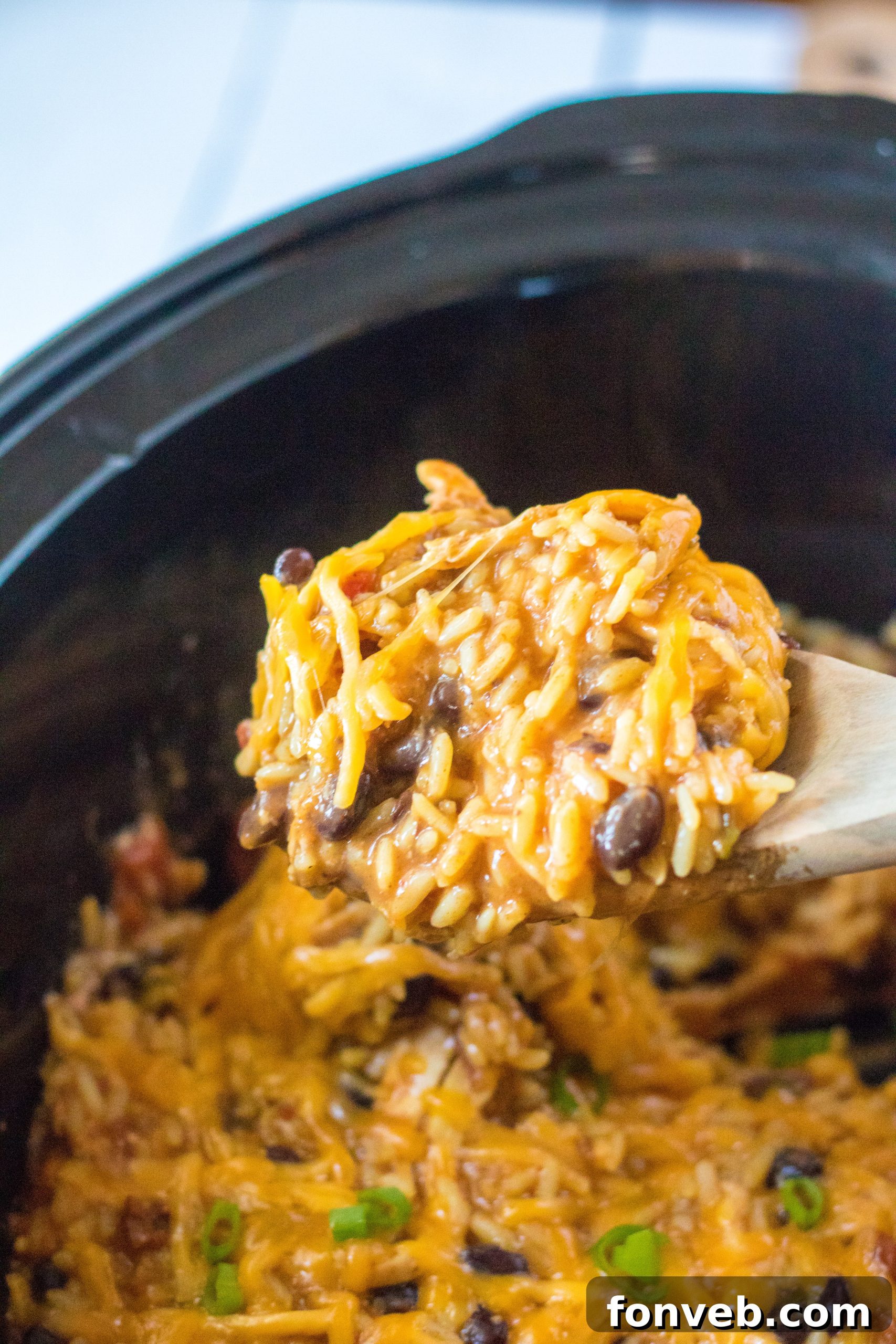 Creamy Slow Cooker Cheesy Chicken Taco Rice 8 Serving of Slow Cooker Cheesy Chicken Taco Rice with a spoon