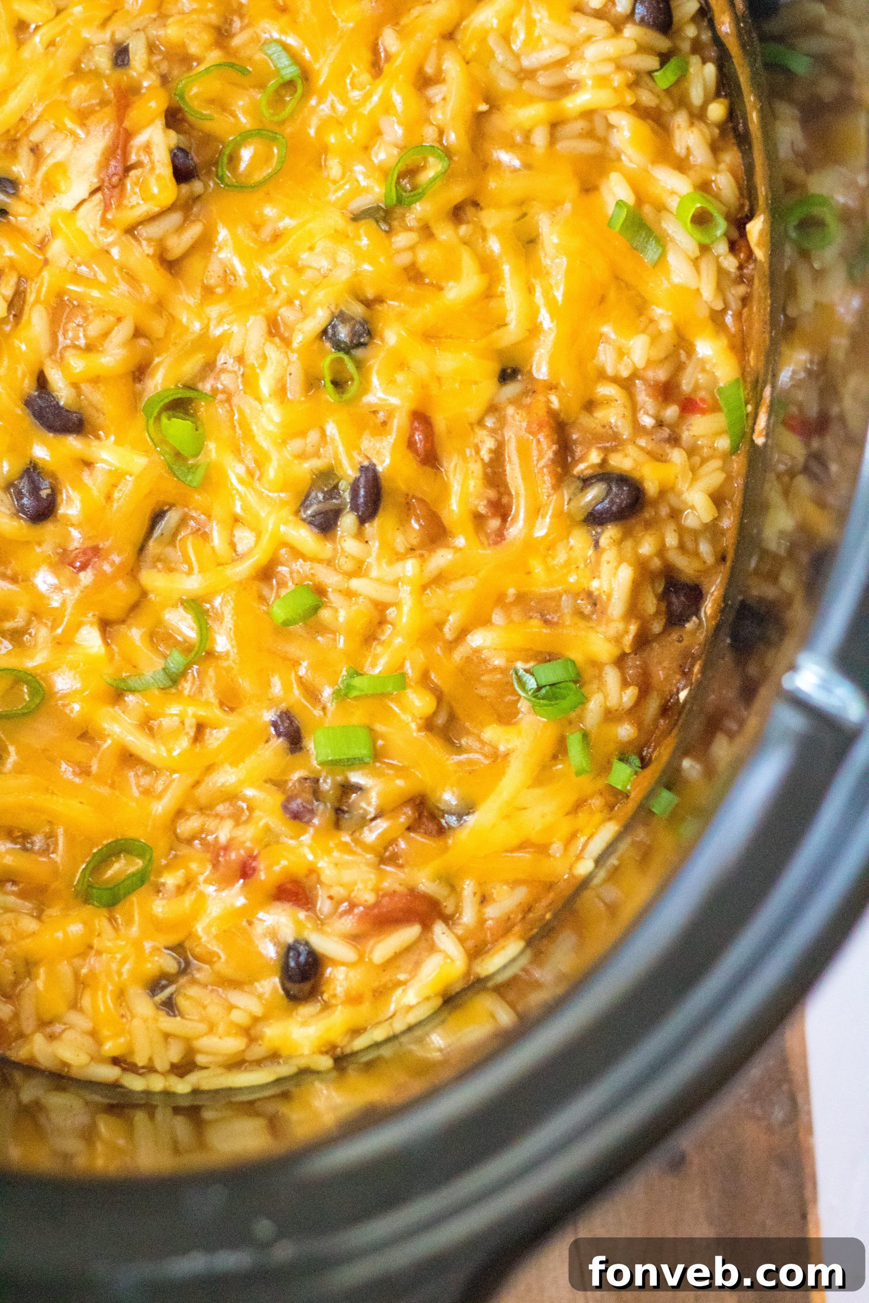 Creamy Slow Cooker Cheesy Chicken Taco Rice 9 Cooked shredded chicken in the slow cooker