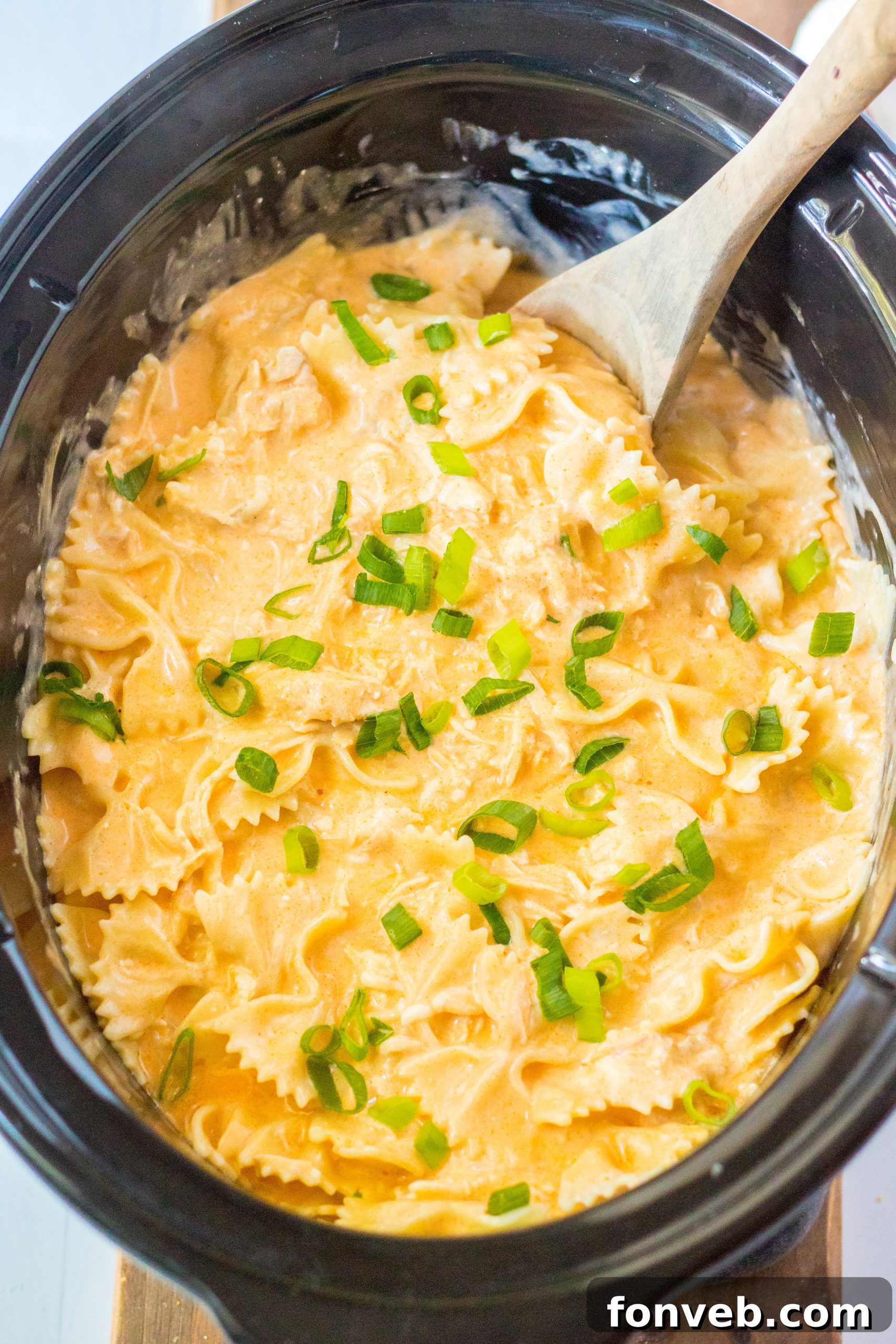 Close-up of creamy slow cooker buffalo chicken pasta in a serving bowl