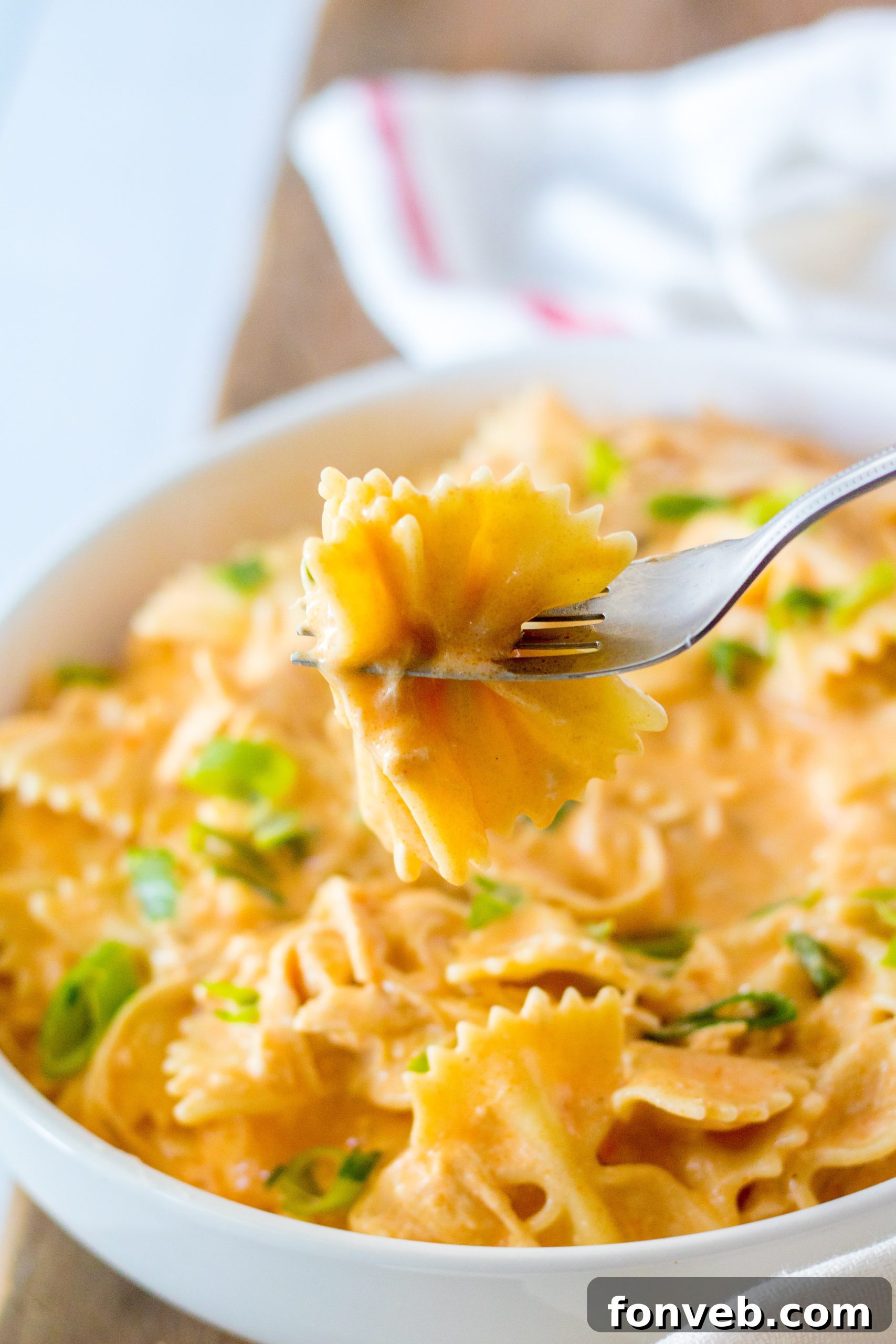 Slow cooker filled with chicken and buffalo sauce mixture before adding pasta.