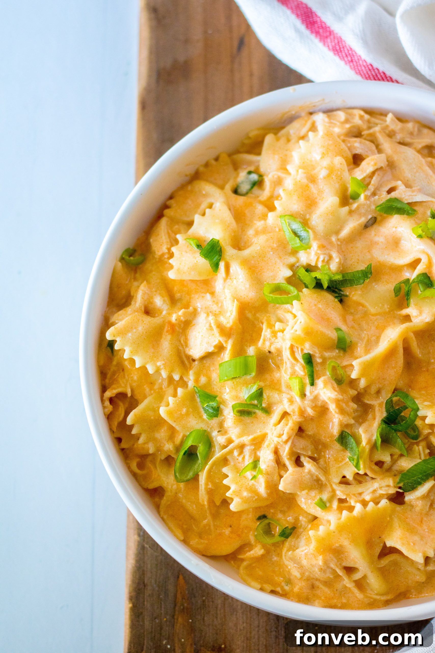 A bowl of cooked pasta ready to be added to the buffalo chicken mixture.