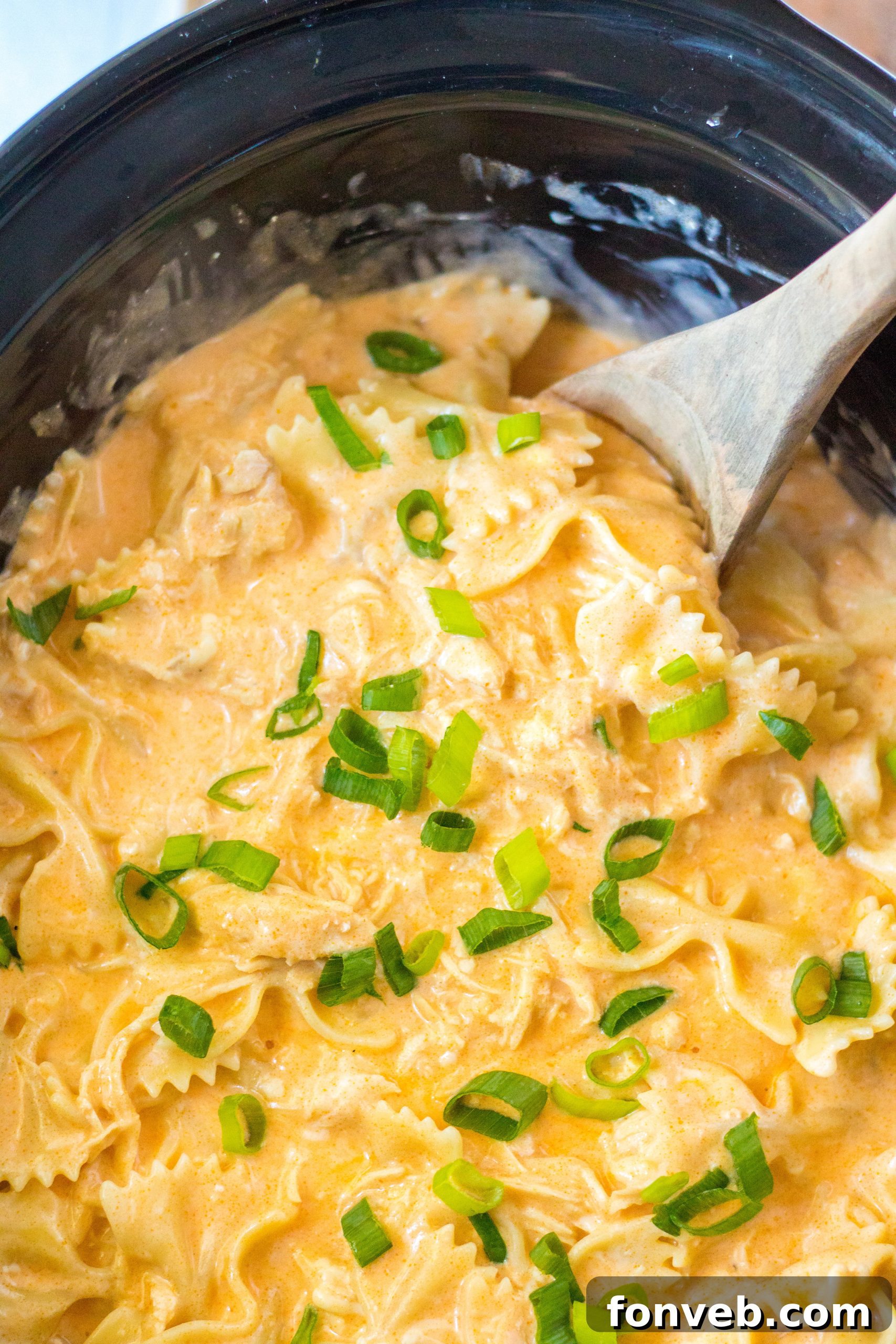 Bottles of various buffalo wing sauces on a kitchen counter.