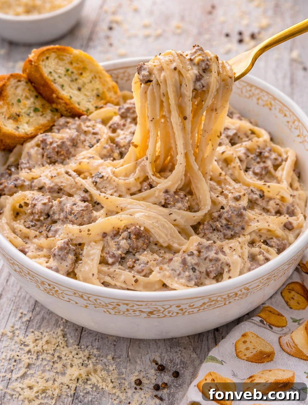 Crock Pot Beef & Noodles in a serving bowl with a spoon