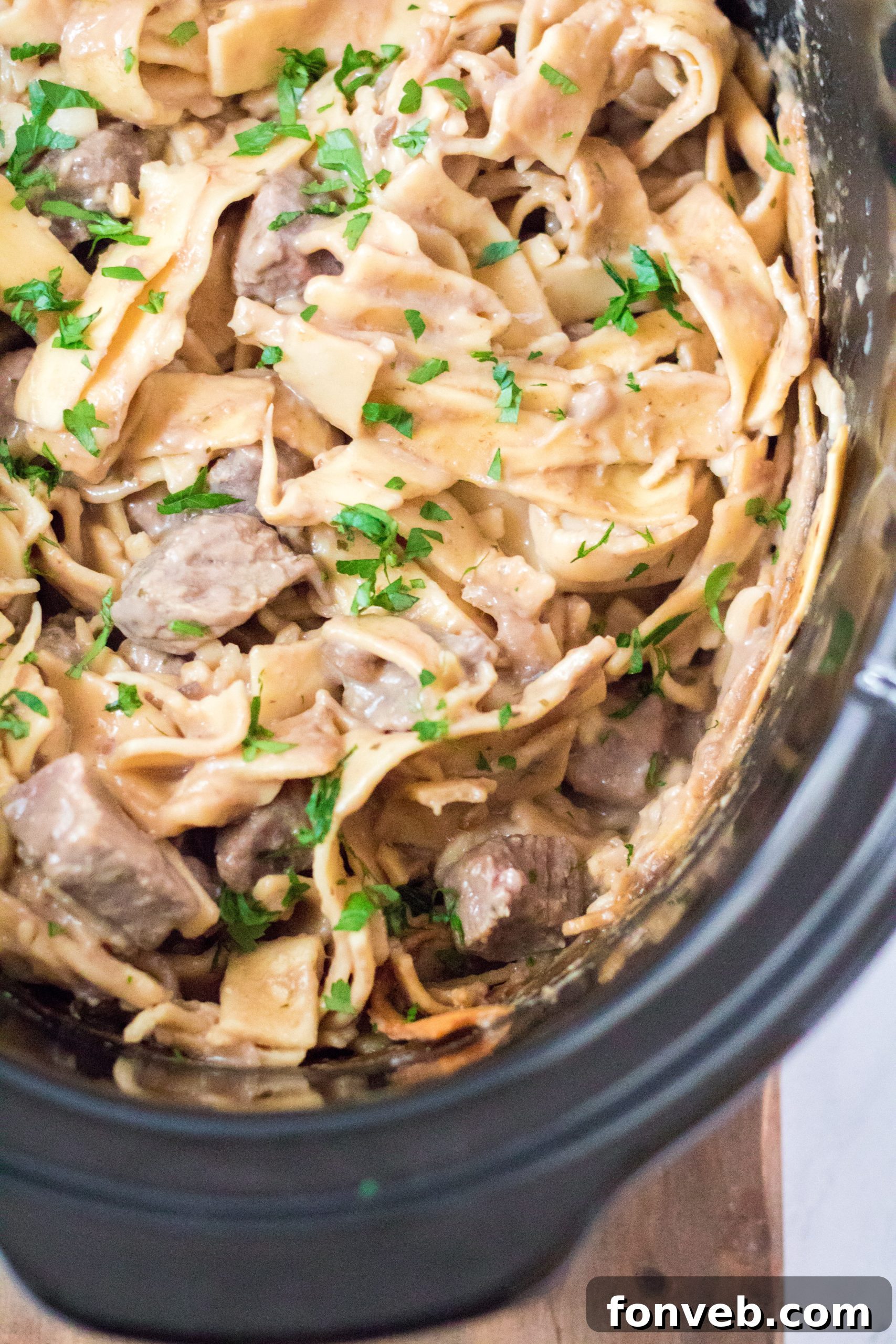 Serving of Crock Pot Beef & Noodles with a garnish
