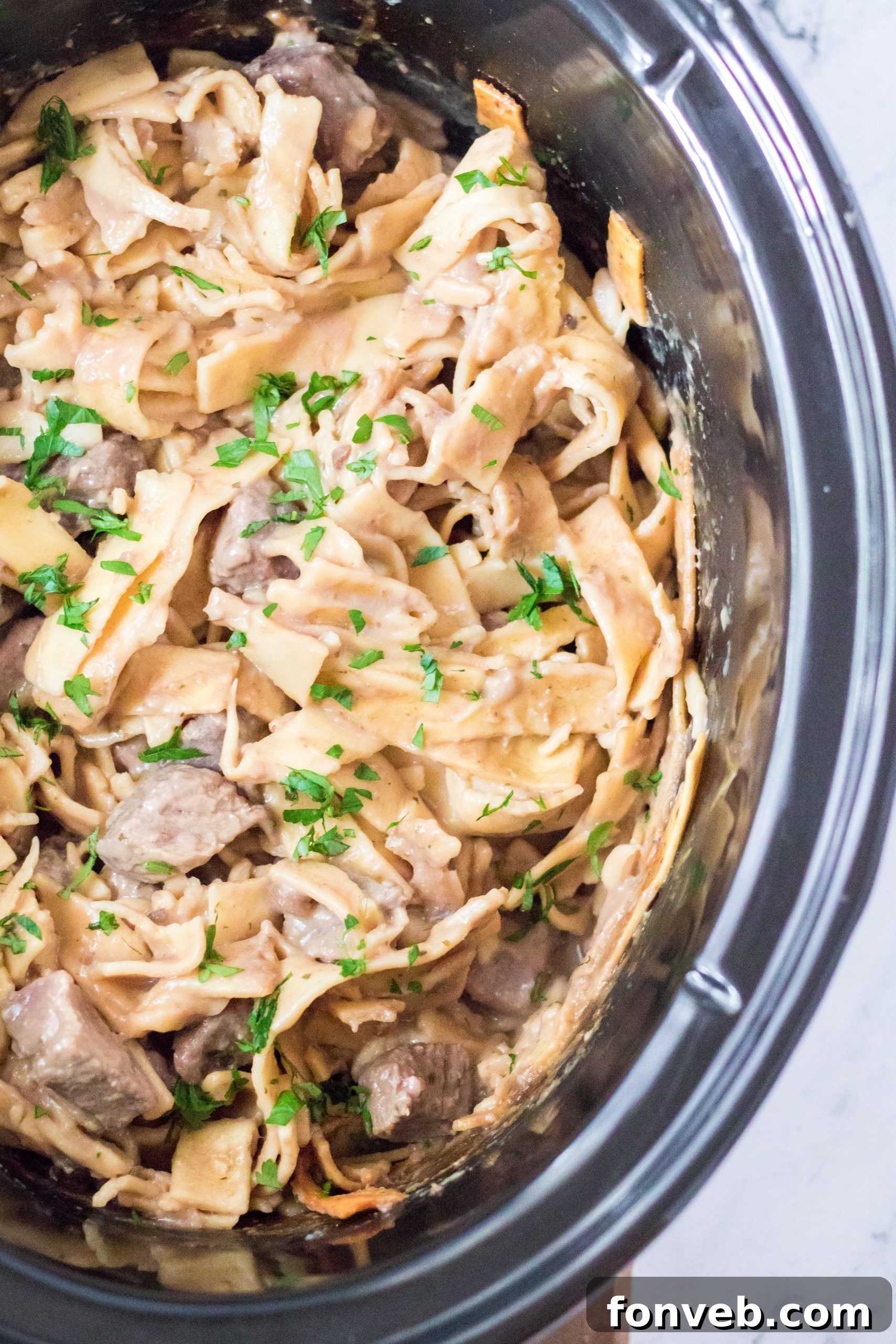 Crock Pot Beef & Noodles garnished with fresh parsley