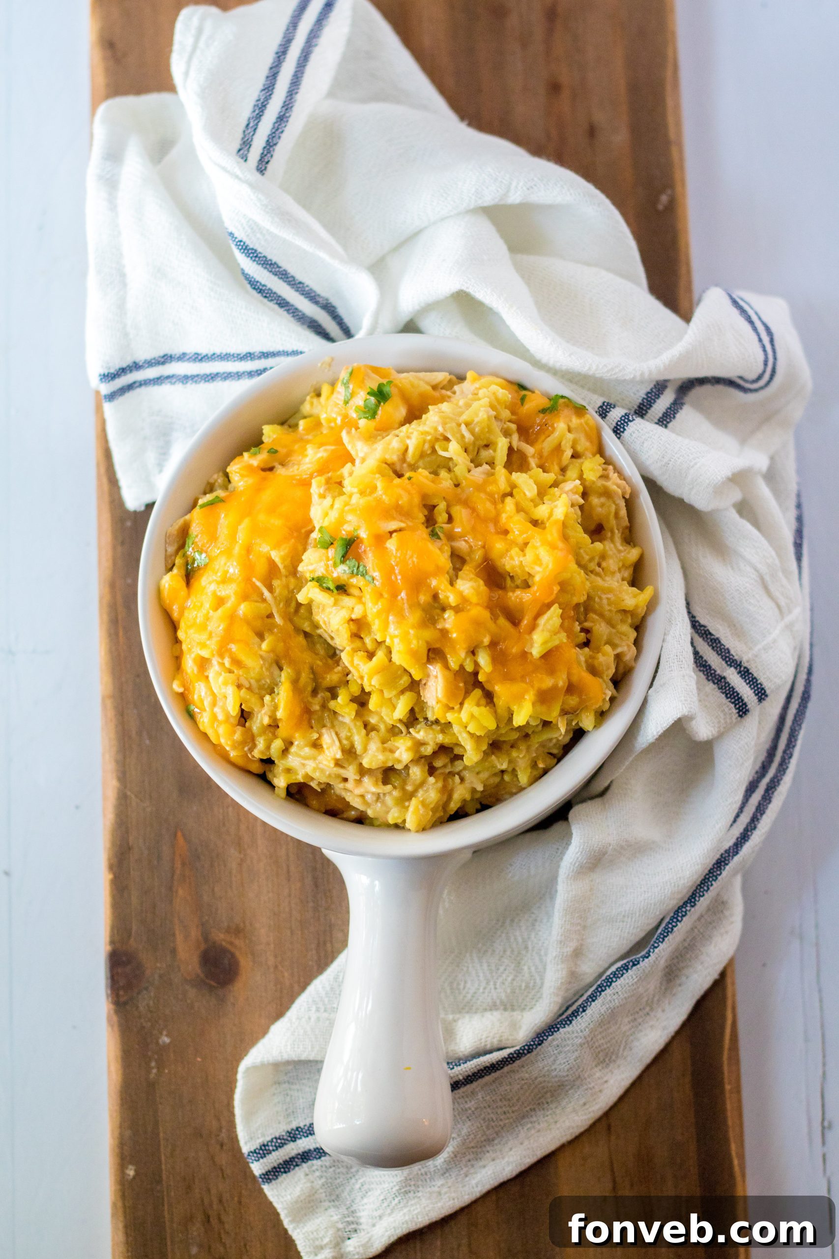 A bowl of Slow Cooker Cheesy Chicken and Rice with a fork.