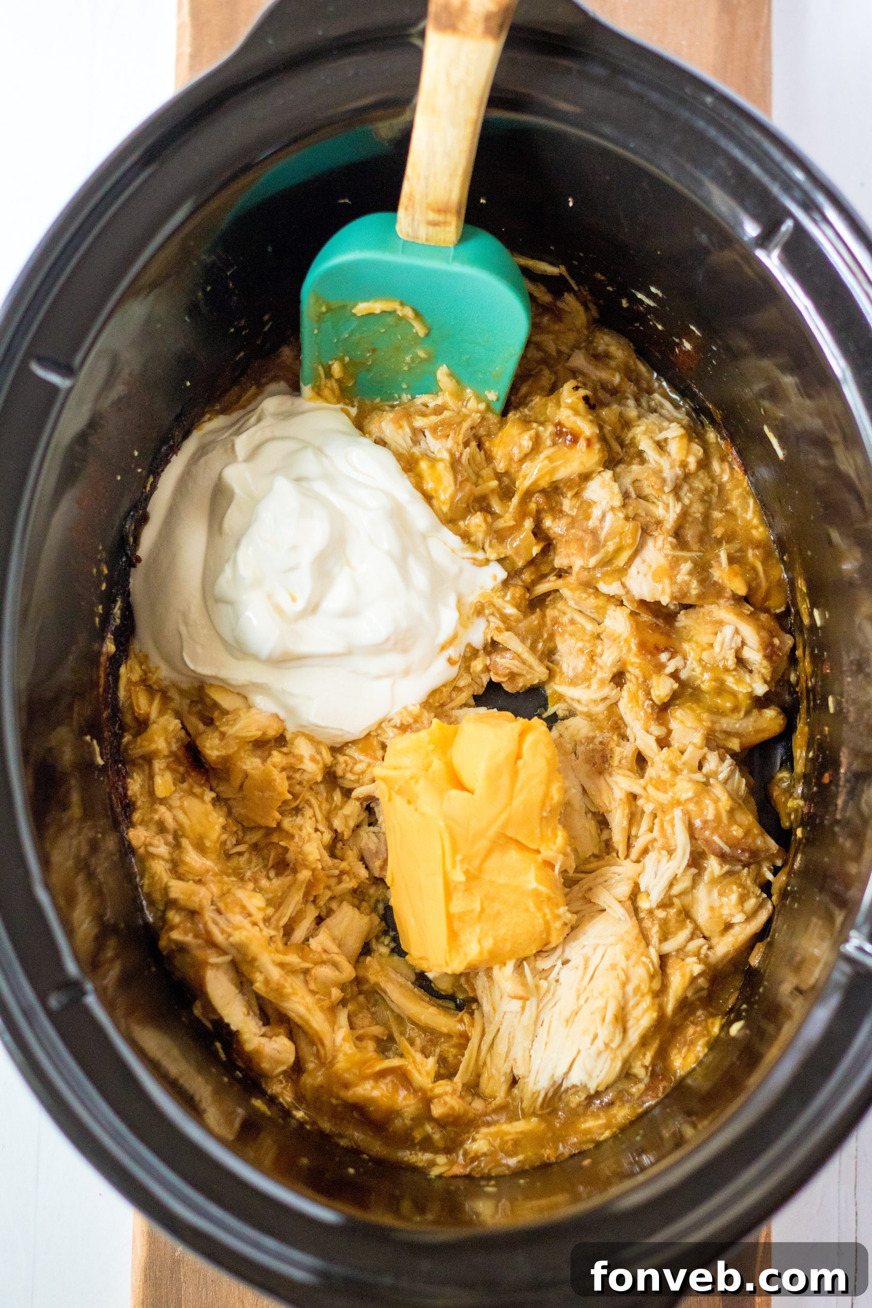 A wider shot of the Slow Cooker Cheesy Chicken and Rice, with side dishes like tortilla chips.