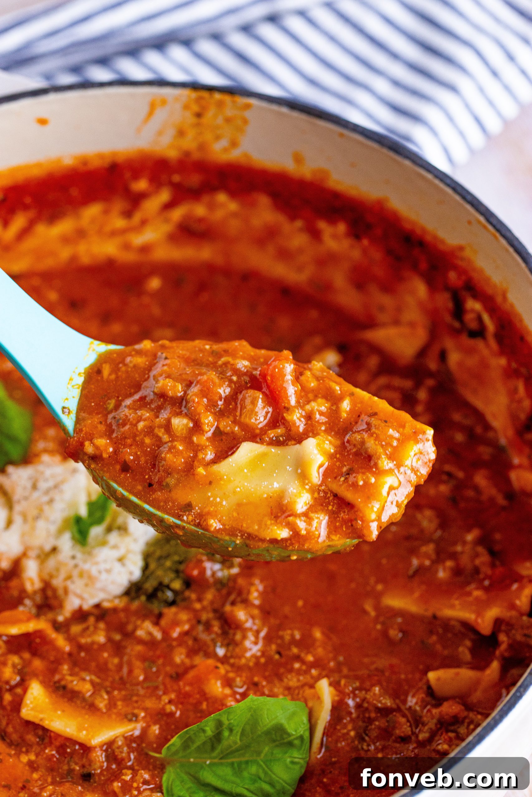 Lasagna Soup topped with a rich cheese mixture and herbs