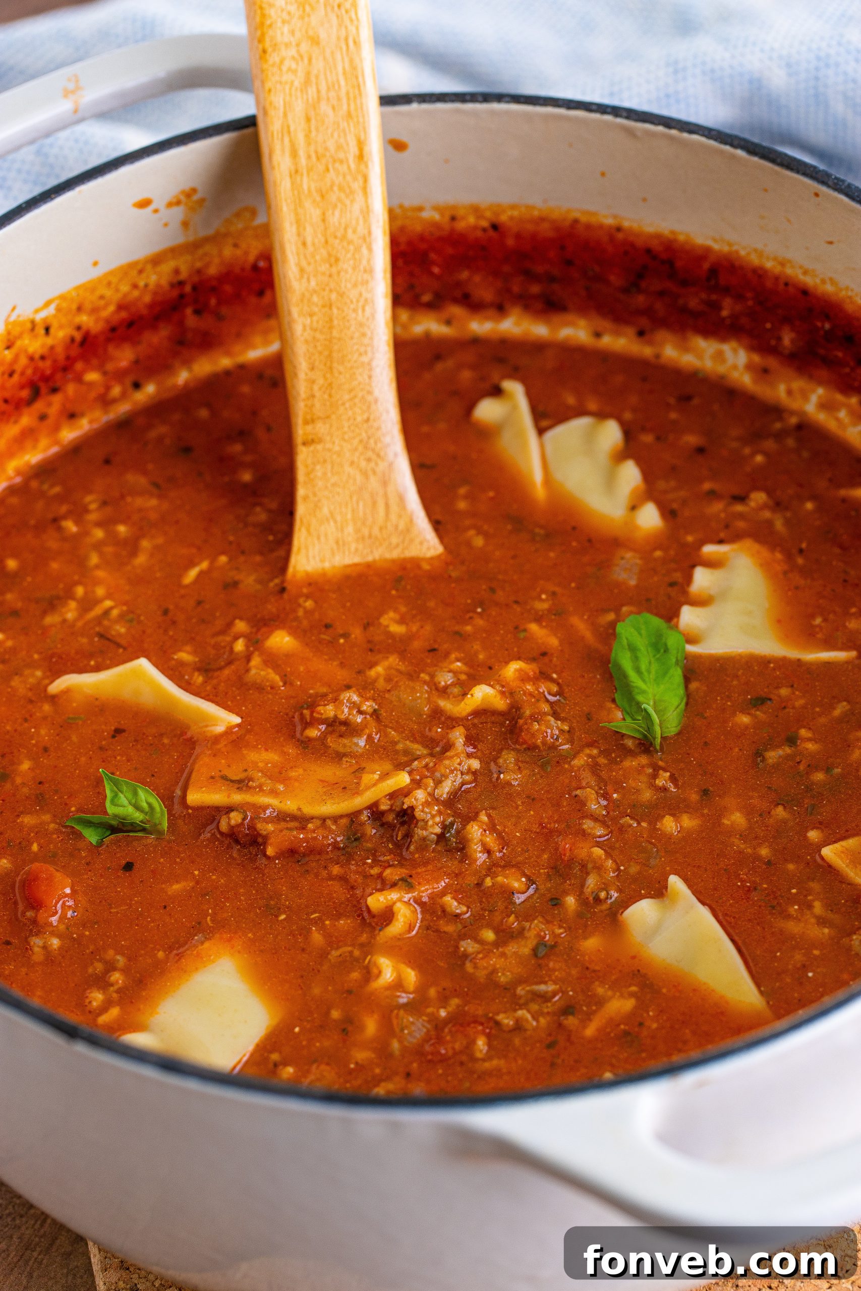 A large pot of Lasagna Soup with a ladle