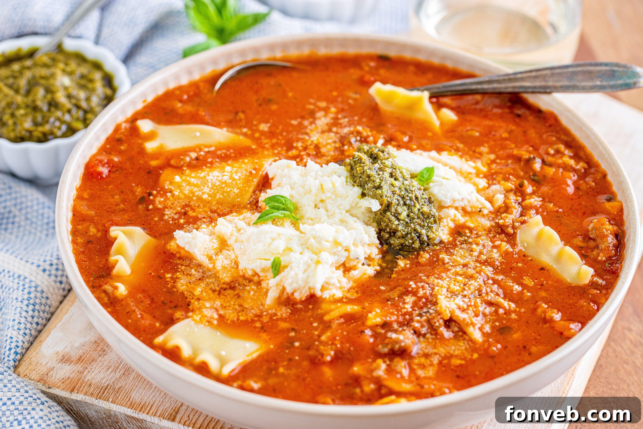 A rustic cutting board with ingredients for soup
