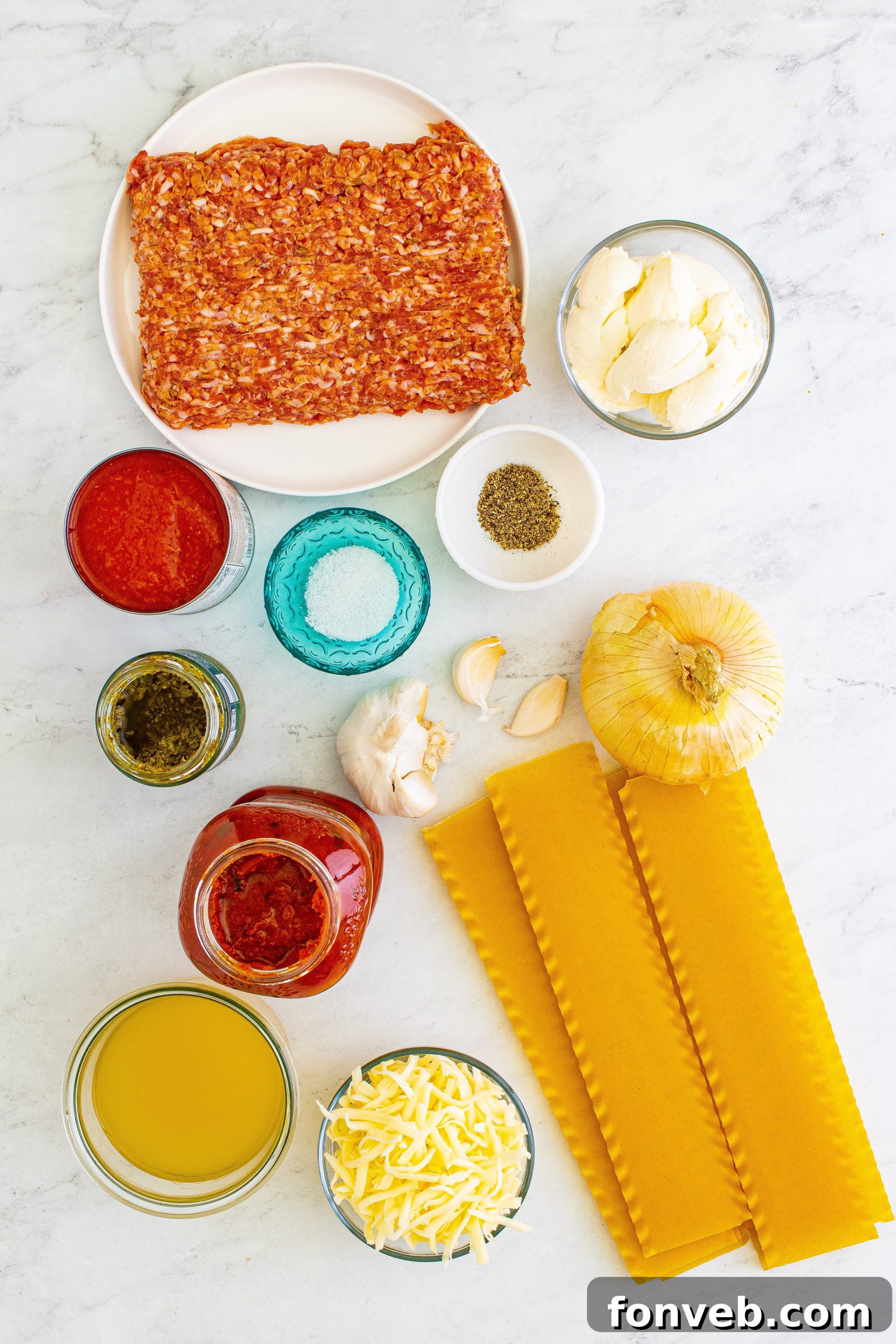Two bowls of Lasagna Soup with fresh ingredients and cheese