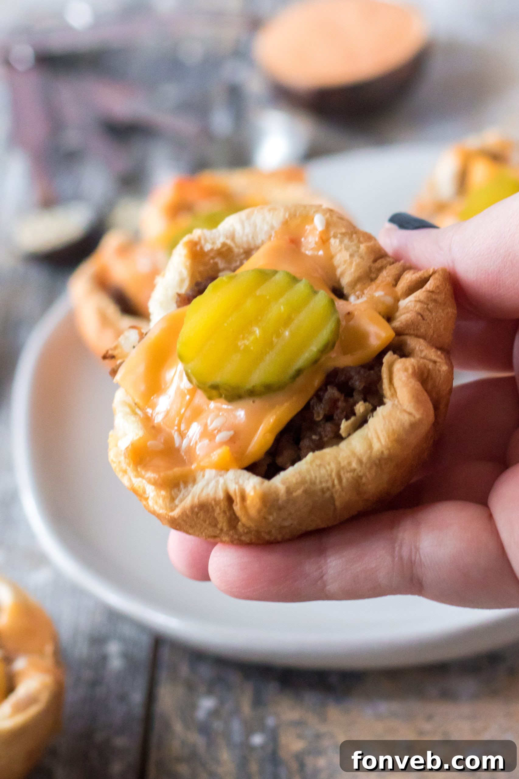 Delicious Big Mac Cups arranged in a muffin tin, fresh out of the oven.