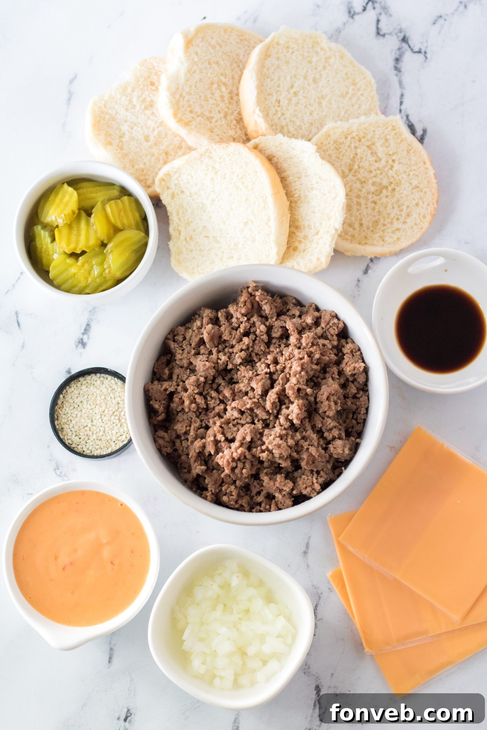A close-up of a single Big Mac Cup, topped with sauce, pickle, and sesame seeds.