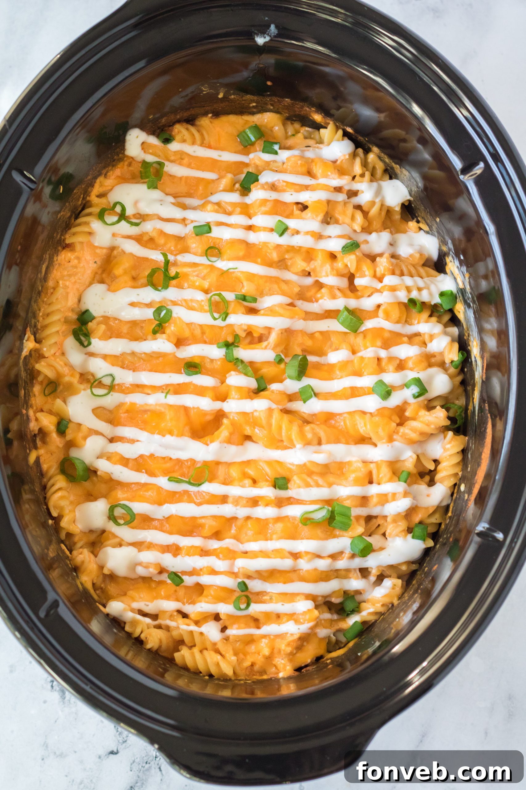 Tangy Slow Cooker Buffalo Chicken Mac and Cheese 15 Slow Cooker Buffalo Chicken Mac & Cheese ready to be served, showing the rich, creamy texture and vibrant color.