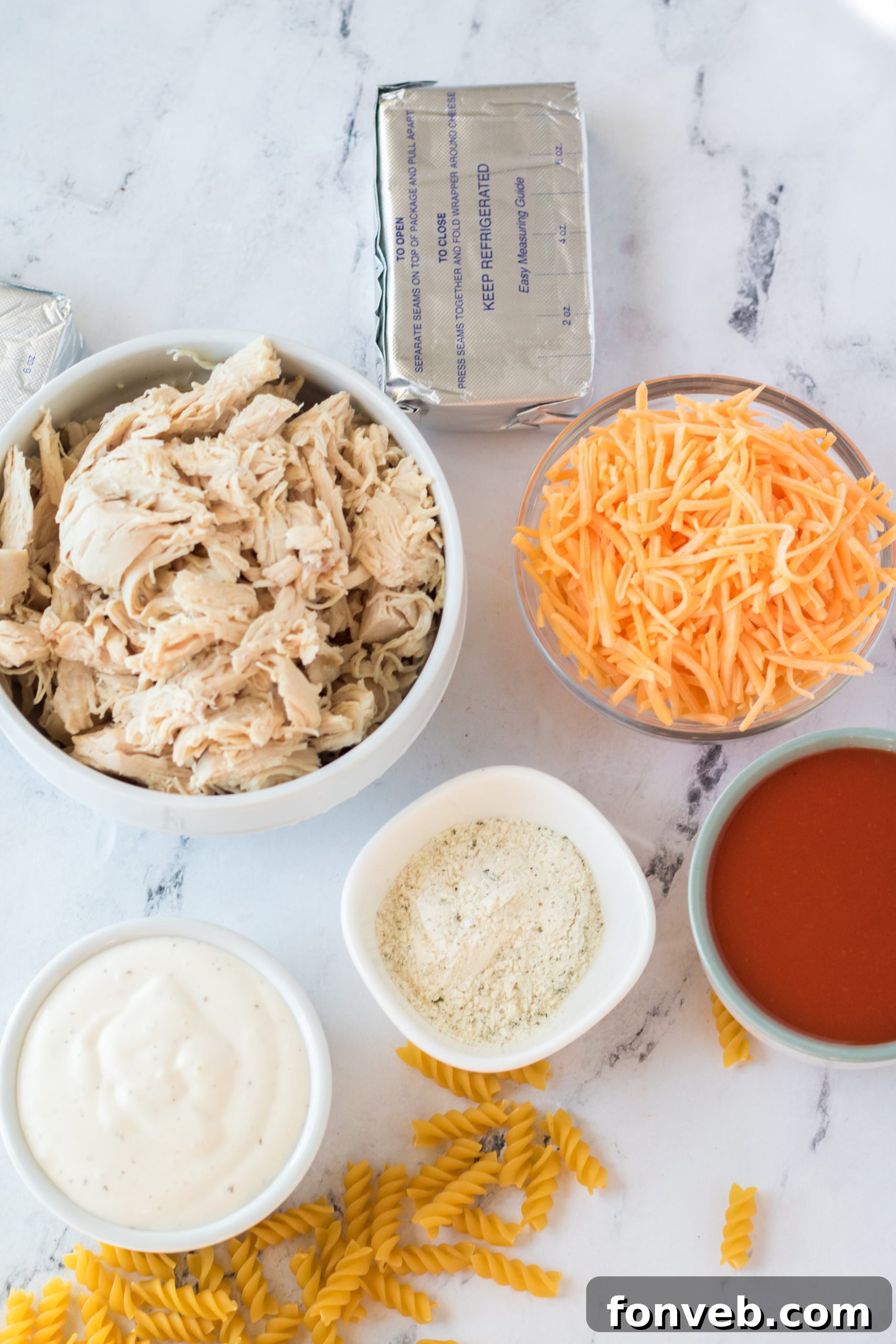 Tangy Slow Cooker Buffalo Chicken Mac and Cheese 3 Close-up of creamy Slow Cooker Buffalo Chicken Mac & Cheese with buffalo sauce drizzle.