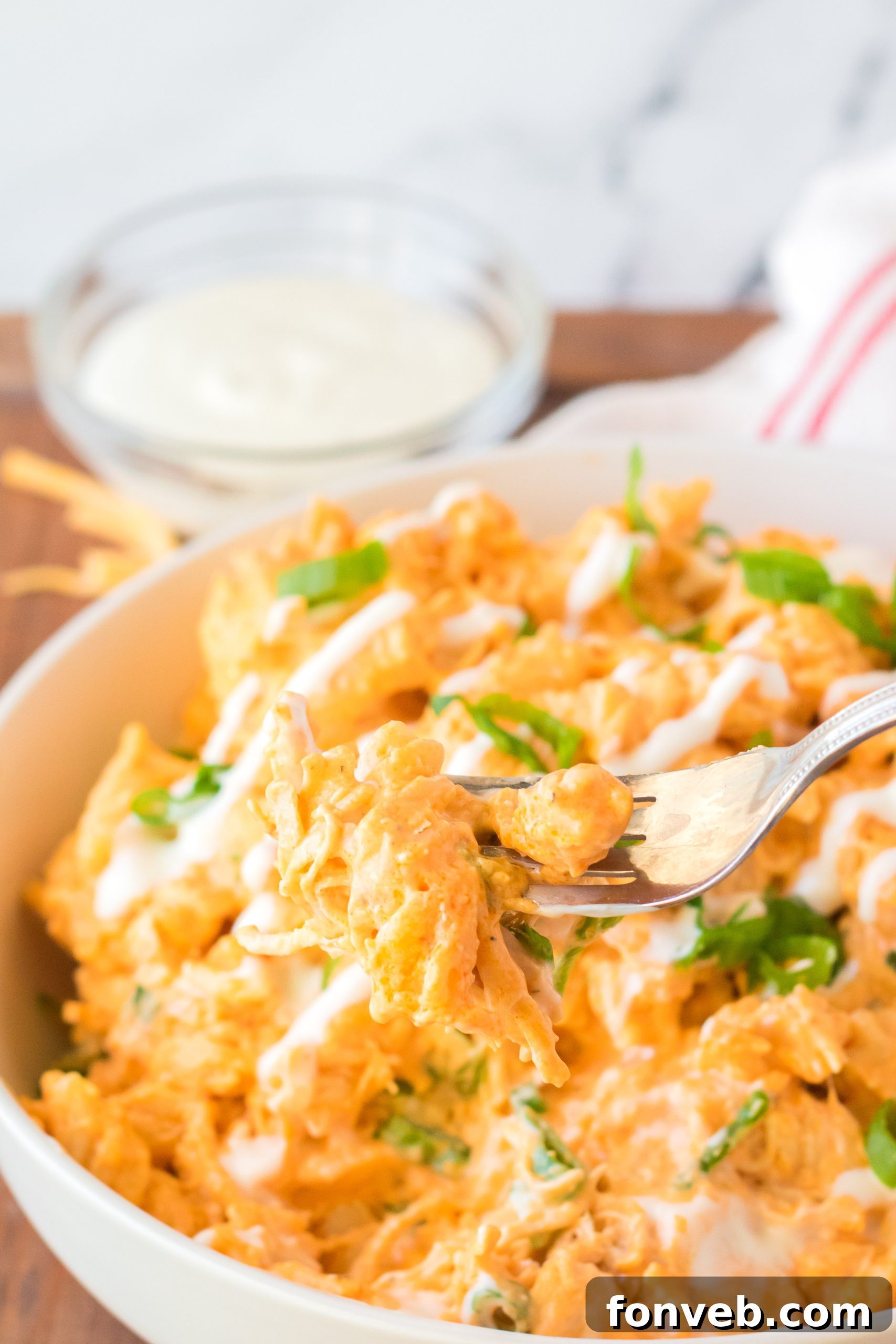 Tangy Slow Cooker Buffalo Chicken Mac and Cheese 5 Ingredients for Slow Cooker Buffalo Chicken Mac & Cheese laid out on a table, including pasta, cheese, chicken, and sauces.