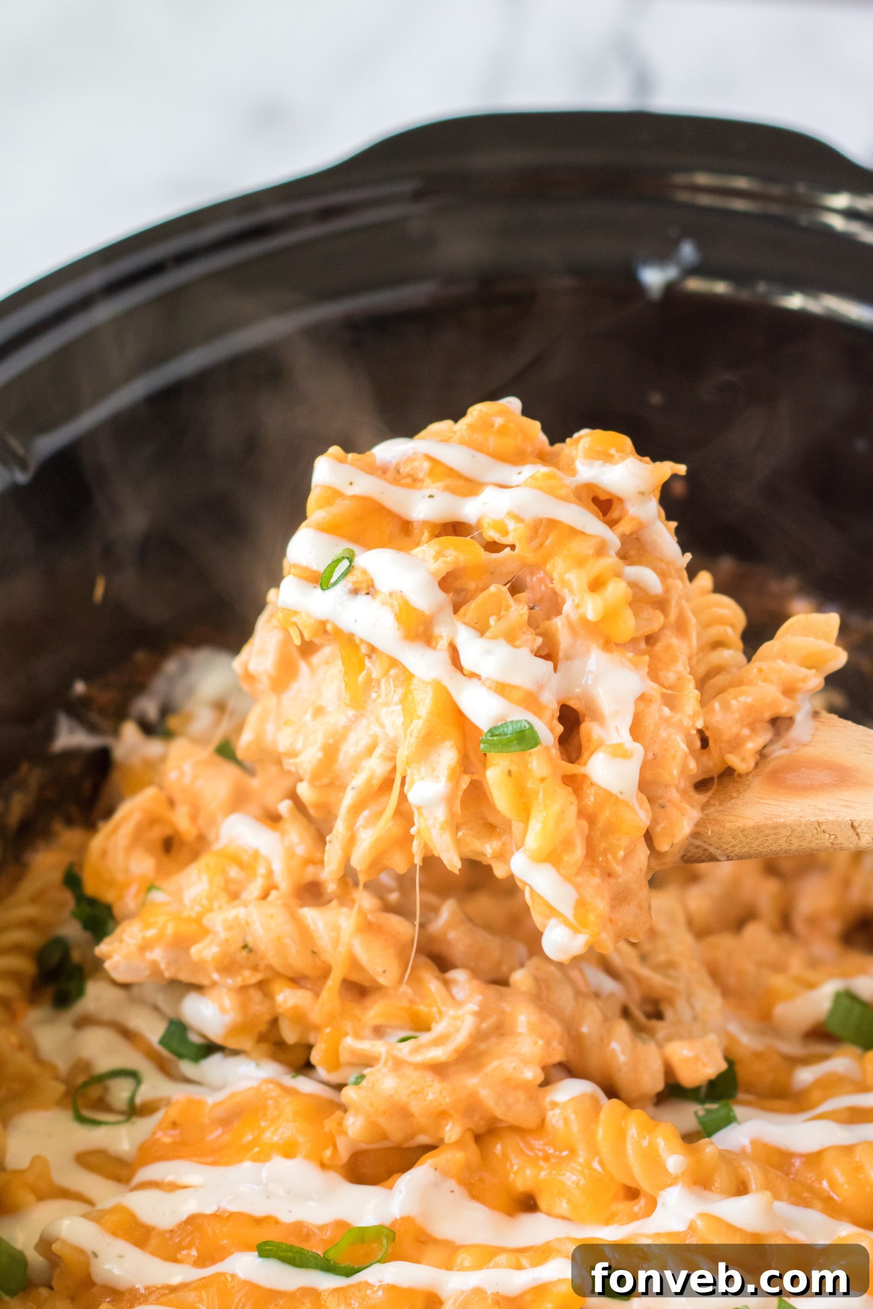 Tangy Slow Cooker Buffalo Chicken Mac and Cheese 8 A close-up of a serving of Slow Cooker Buffalo Chicken Mac & Cheese in a bowl.
