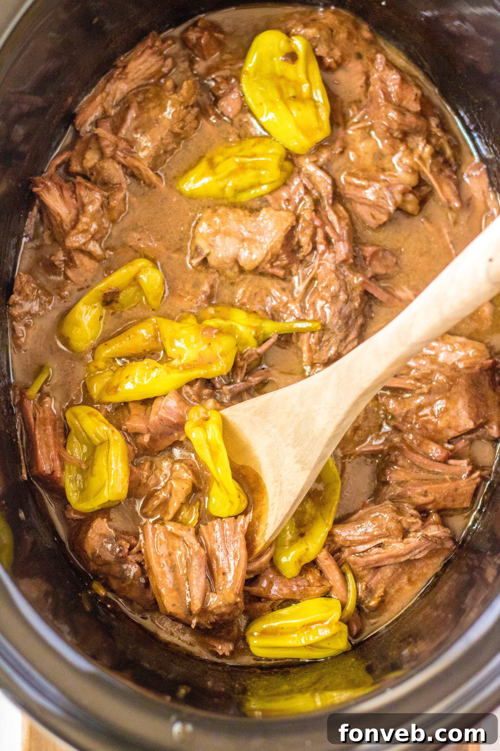 Melt-in-Your-Mouth Slow Cooker Mississippi Pot Roast 12 A bowl of mashed potatoes and green beans next to a platter of Mississippi Pot Roast.