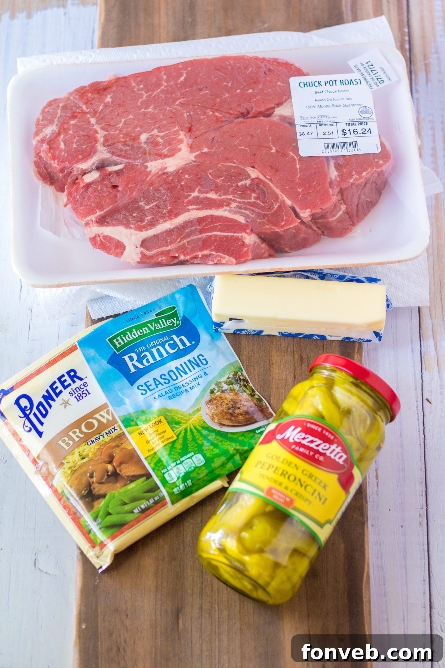 Melt-in-Your-Mouth Slow Cooker Mississippi Pot Roast 3 Close-up of shredded Slow Cooker Mississippi Pot Roast with visible sauce and pepperoncinis.