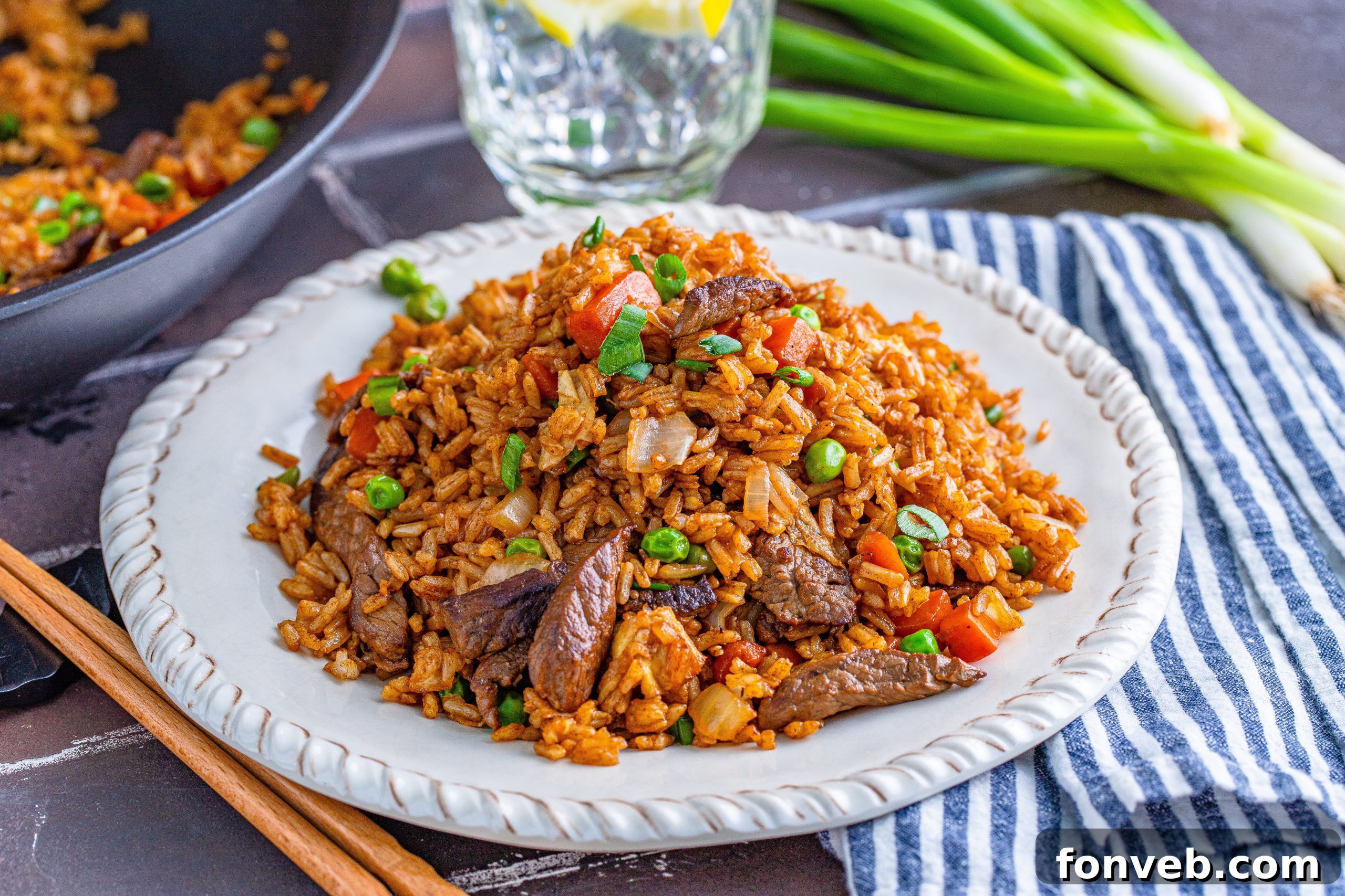 A perfectly prepared bowl of Beef Fried Rice, generously garnished with finely chopped scallions.