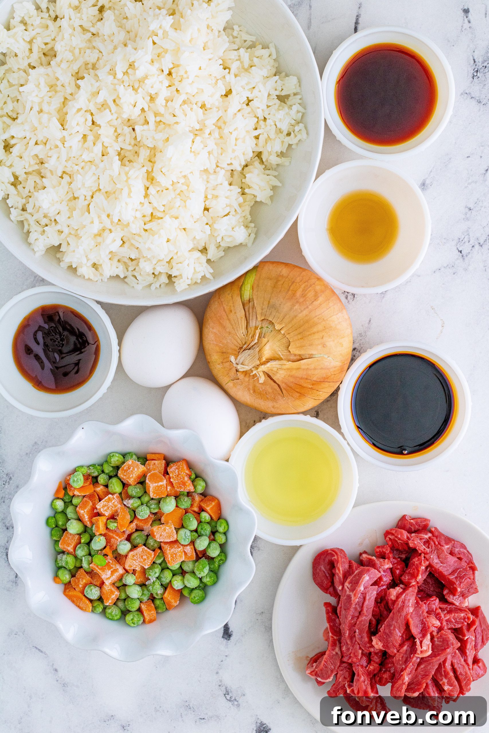 Close-up view of Beef Fried Rice showing tender pieces of sirloin steak and colorful peas and carrots.