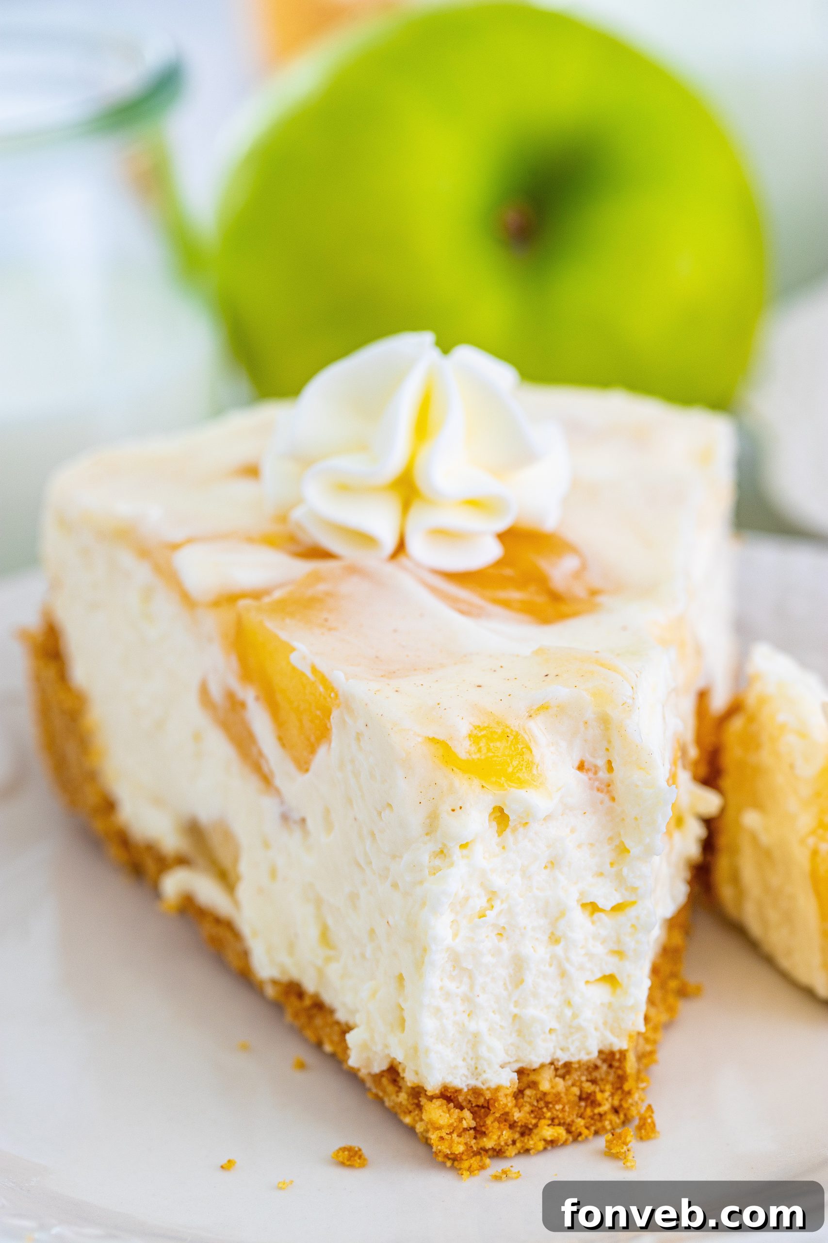 Chilled Apple Pie Cheesecake 10 A hand mixing the cheesecake filling in a bowl.